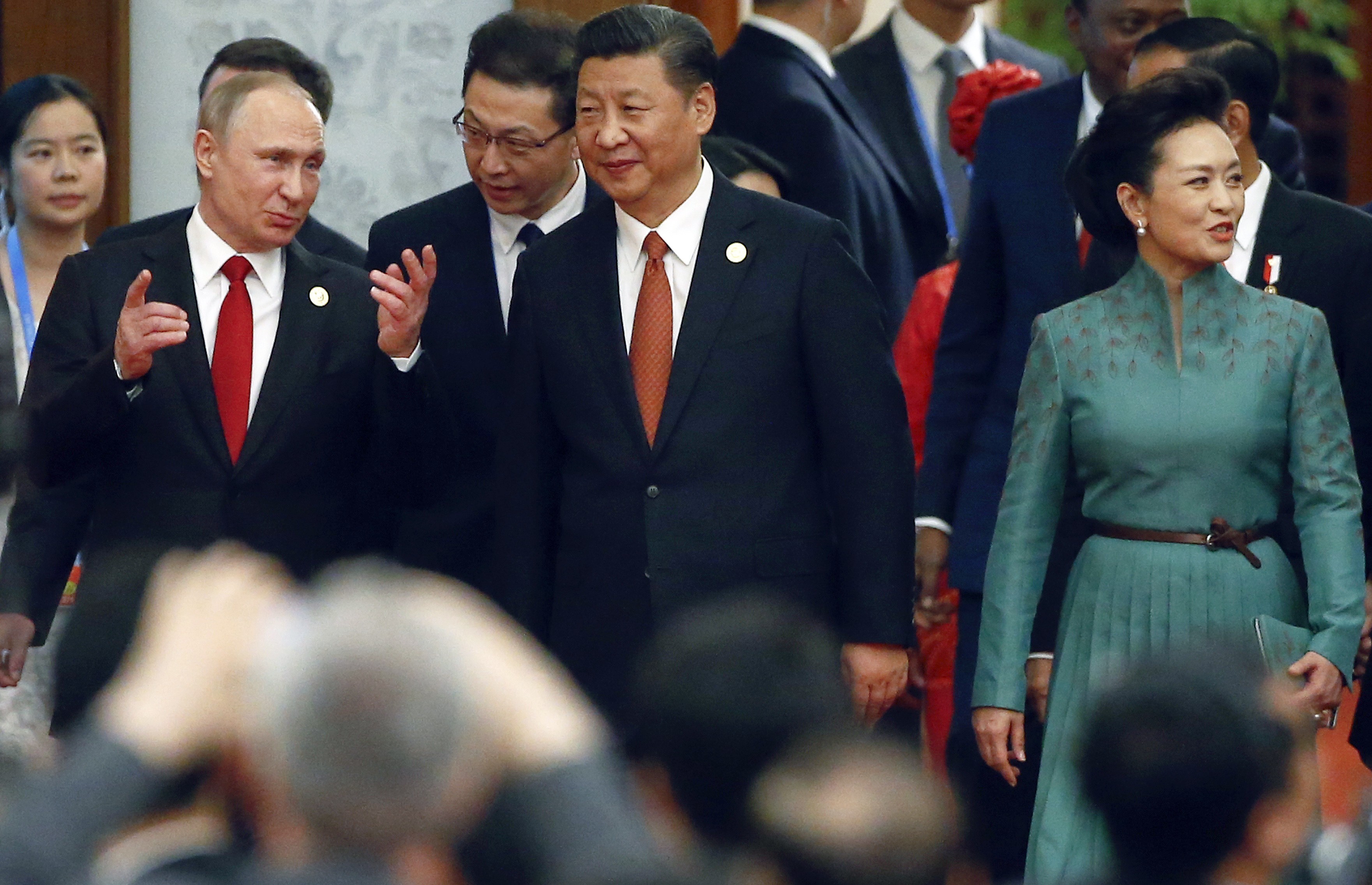 Chinese President Xi Jinping, centre, his wife Peng Liyuan and Russian President Vladimir Putin, left, arrive for a welcome banquet for the Belt and Road Forum at the Great Hall of the People in Beijing, Sunday, May 14, 2017. Photo: AP