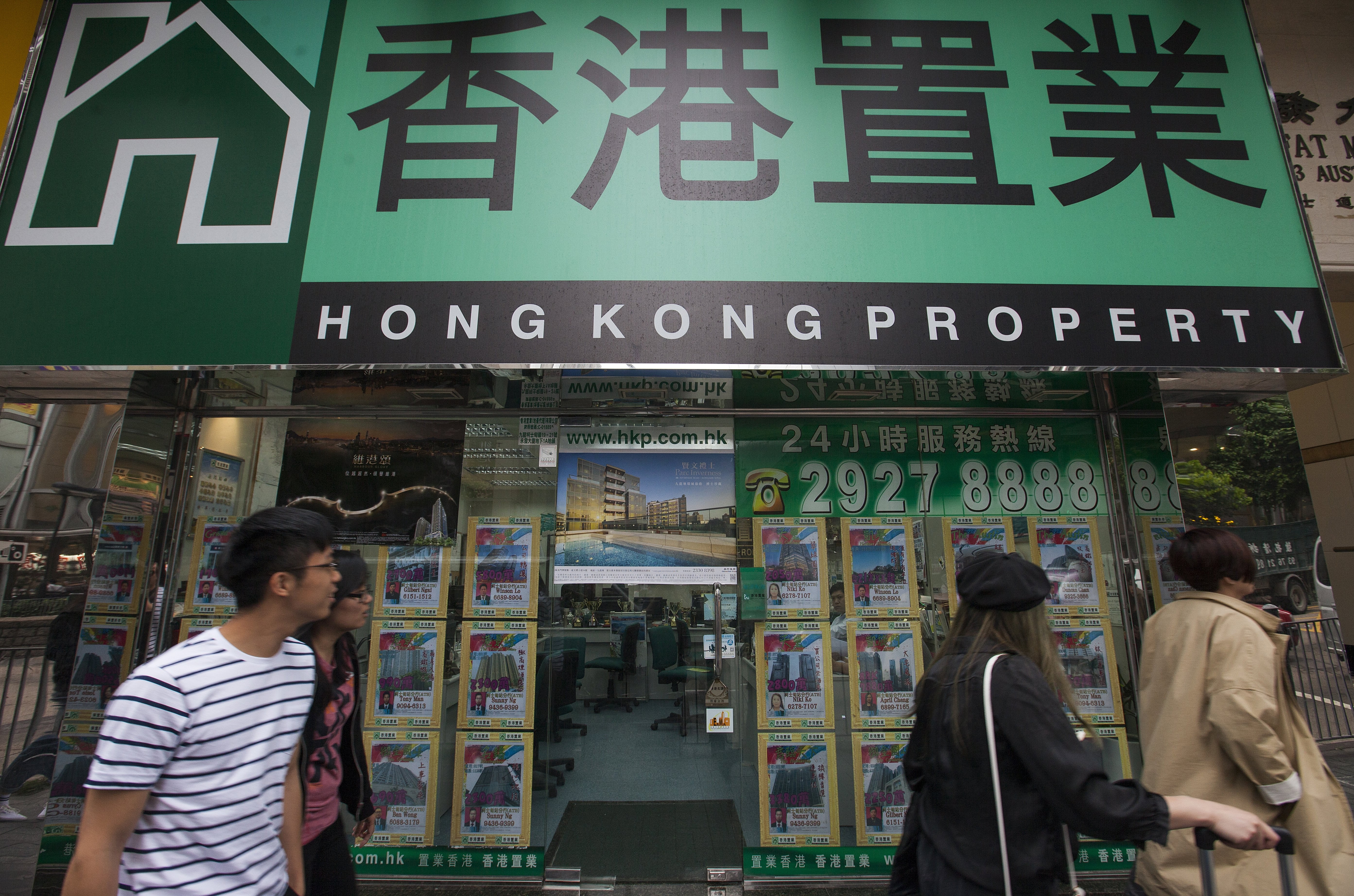 A real estate agent on Austin Road in Tsim Sha Tsui, Kowloon. Richard Wong says that limiting speculation without harming the market adjustment process is a tricky process, adding that common measures such as transaction levies, capital gains taxes, and regulating loan-to-value ratios may help to eliminate short-term speculators, are not neutral in the long run. Photo: EPA