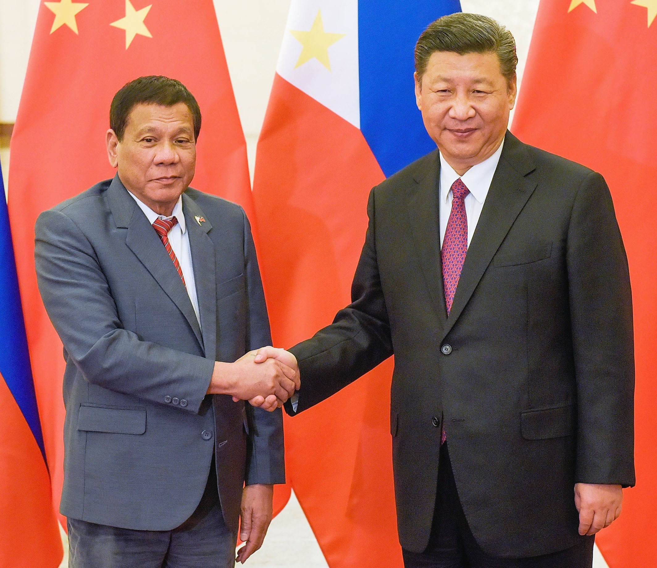 Philippine President Rodrigo Duterte and President Xi Jinping shake hands at Beijing's Great Hall of the People on Monday. Photo: Kyodo