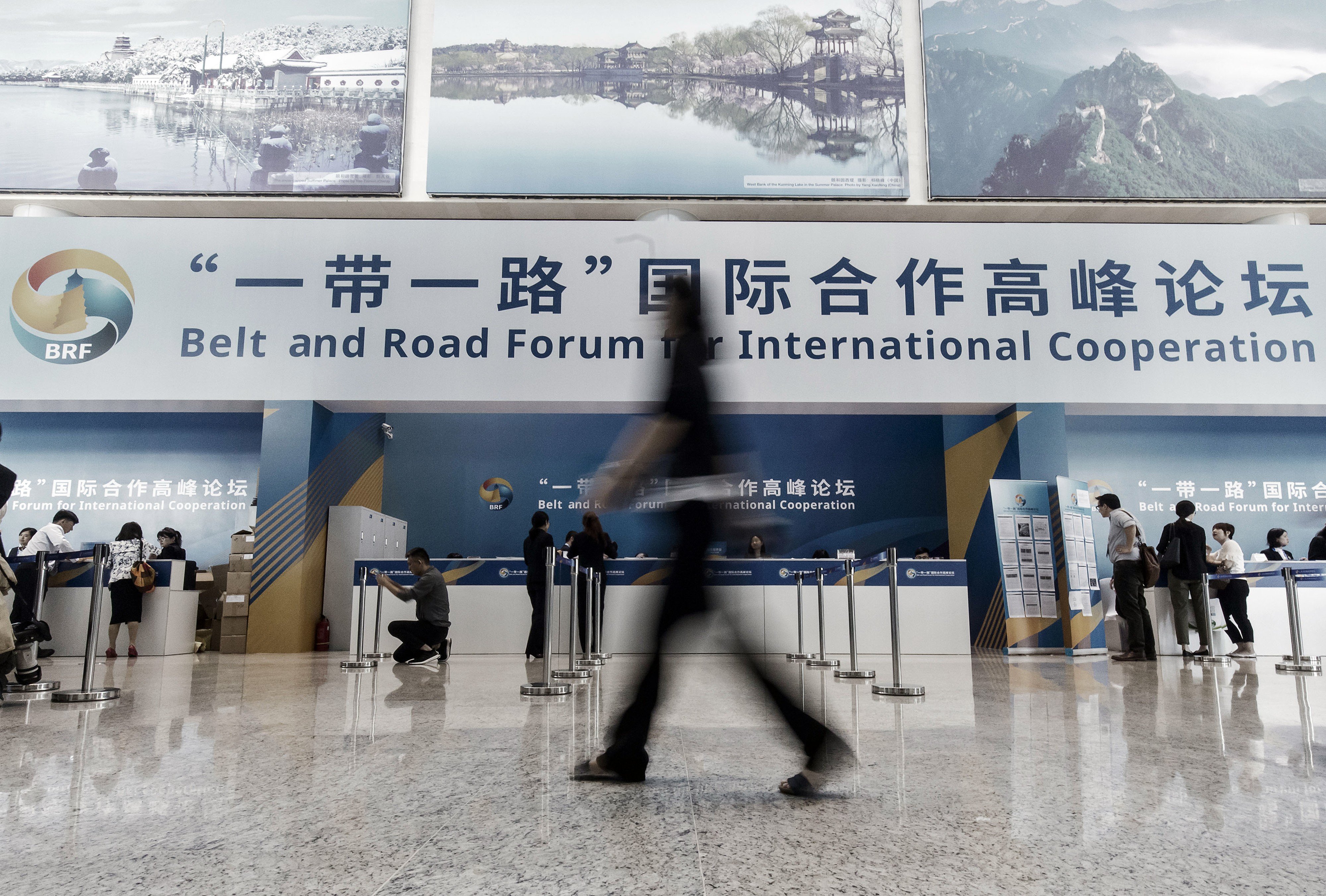 An attendee walks past registration counters at the media centre for the Belt and Road Forum For International Cooperation at the National Convention Centre in Beijing on Sunday. Photo: Bloomberg