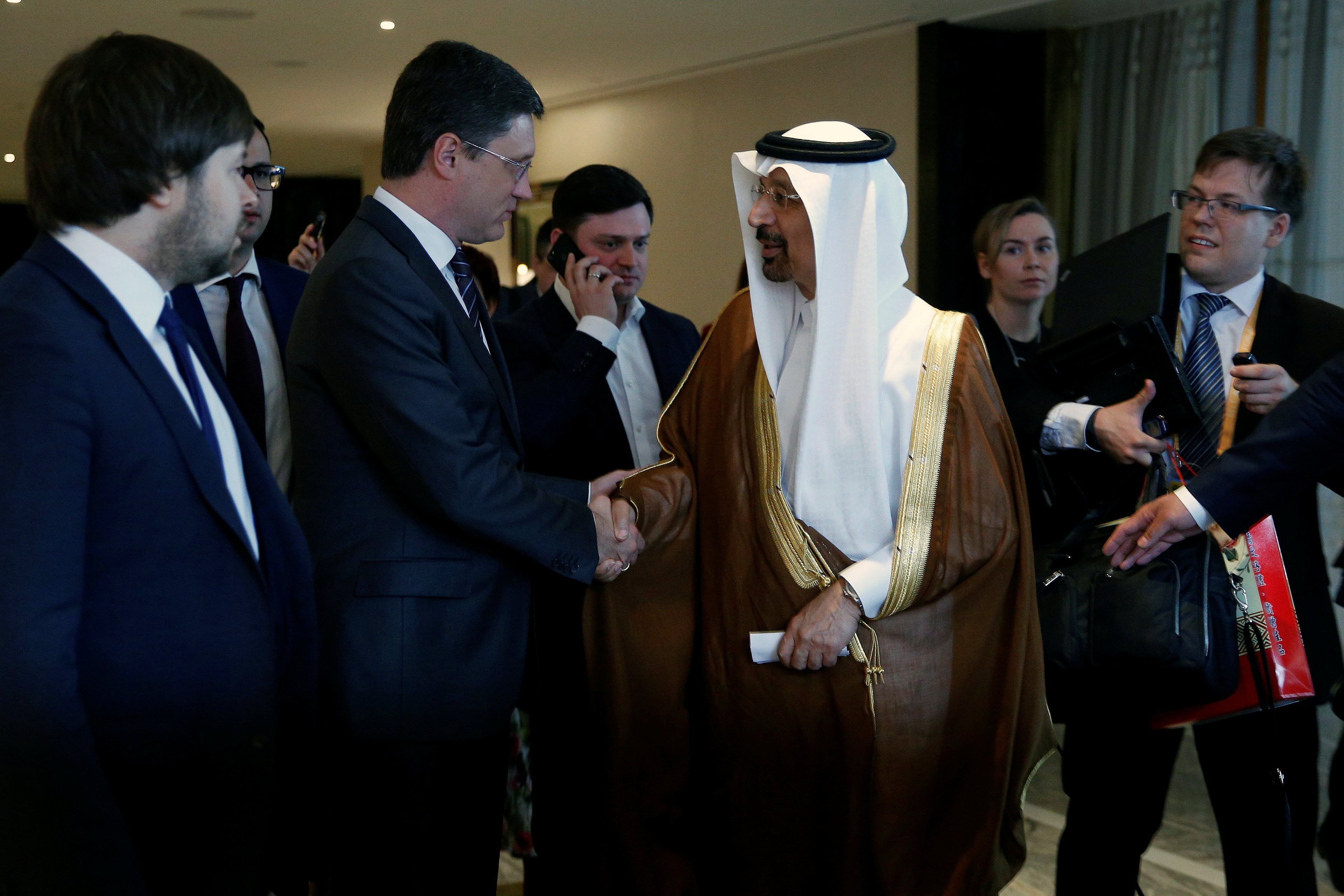 Saudi Arabia's Energy Minister Khalid al-Falih and Russia's Energy Minister Alexander Novak shake hands after a joint briefing in Beijing, China, as an OPEC meeting next week is expected to extend production cuts into 2018. Photo: Reuters