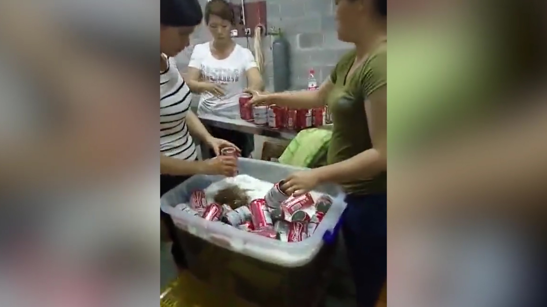 Workers shown in the video putting beer into used cans. Photo: Handout