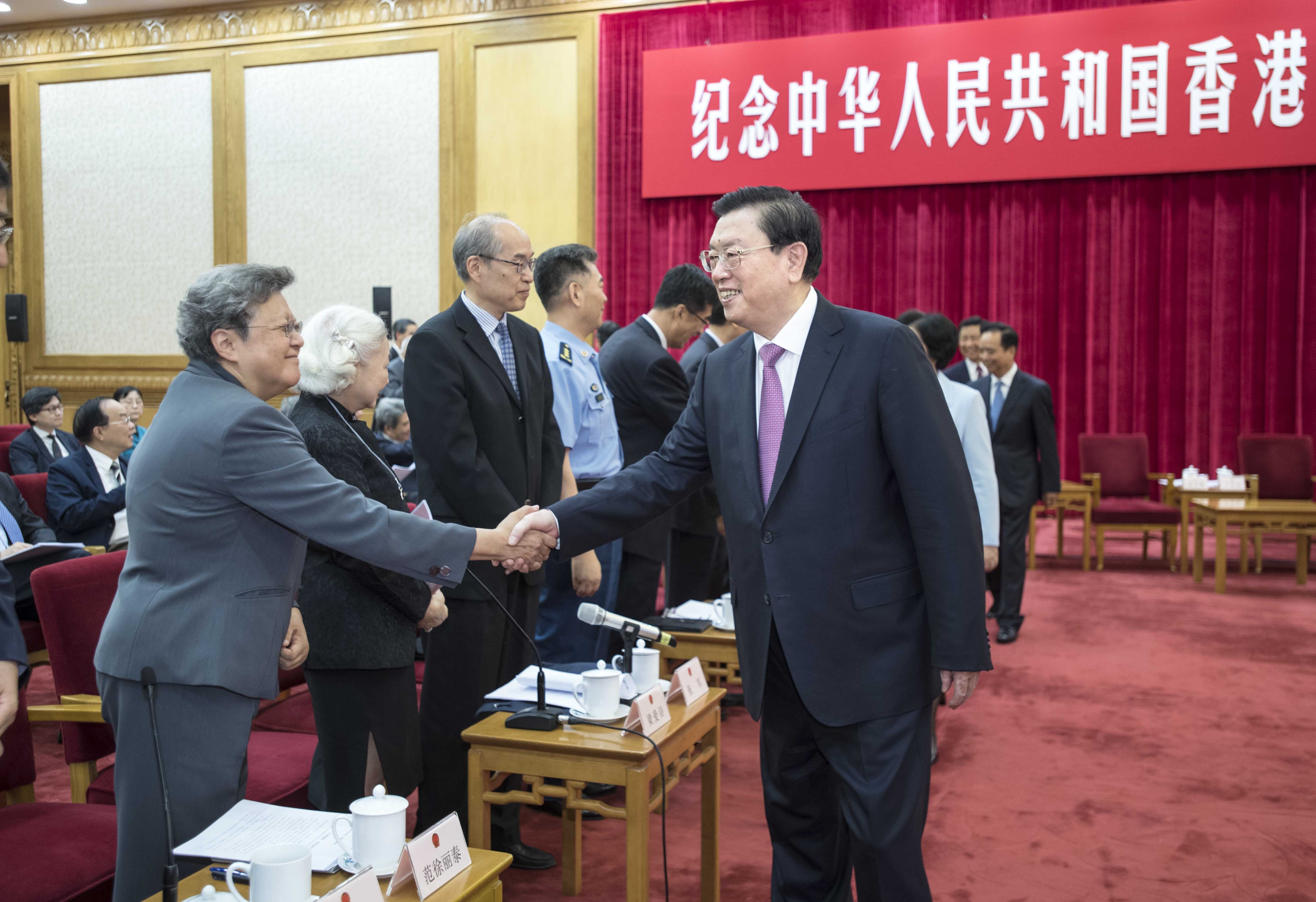 Zhang Dejiang shakes hands with Hong Kong’s Rita Fan Hsu Lai-tai, a member of the NPC Standing Committee, at a high-ranking symposium commemorating the 20th anniversary of the implementation of the Basic Law, at the Great Hall of the People in Beijing on May 27. Photo: Xinhua