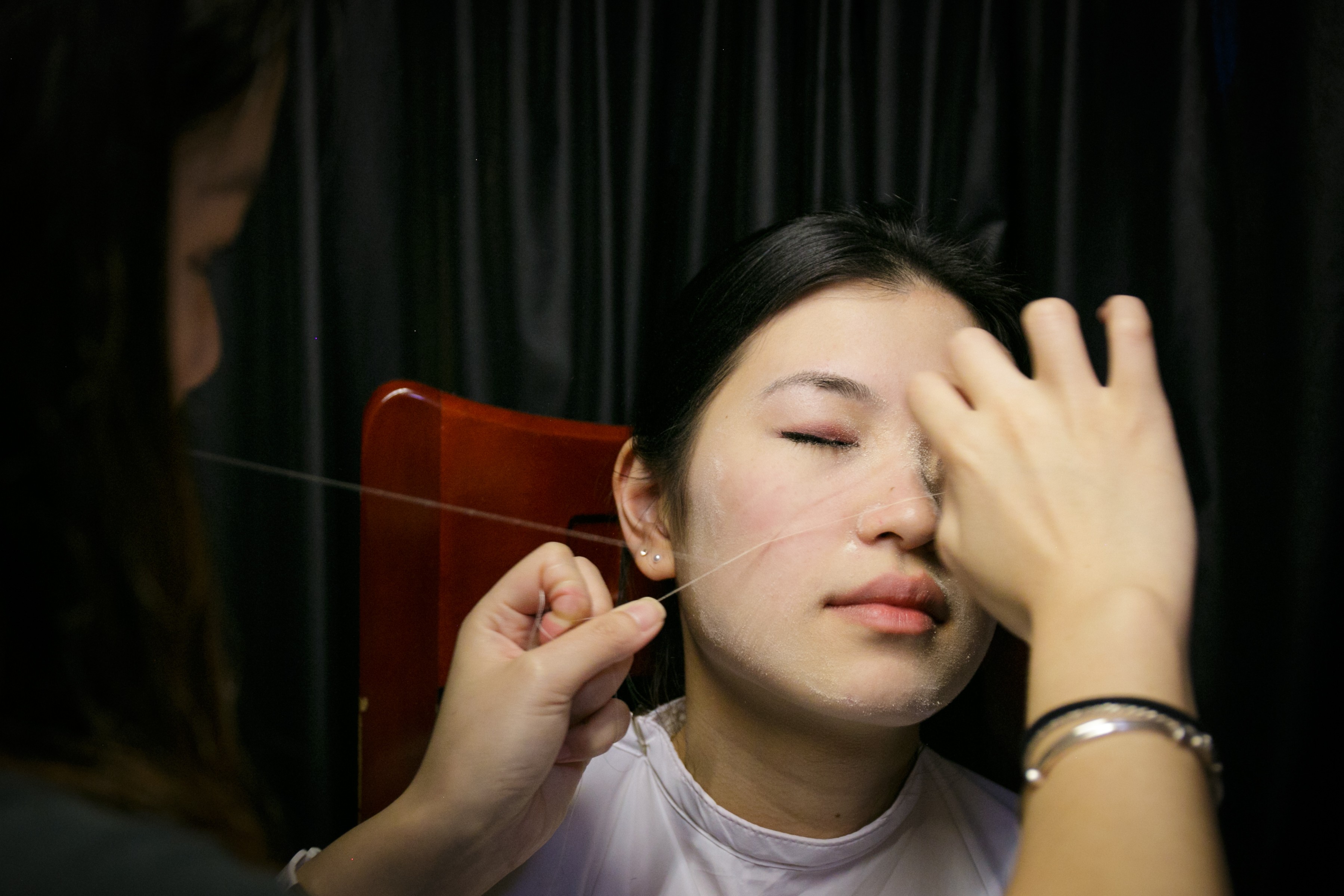 Moona Kwok, 24, inherited the face threading business from her mother, but knows of few other people her age practising it. Photo: Tessa Chan