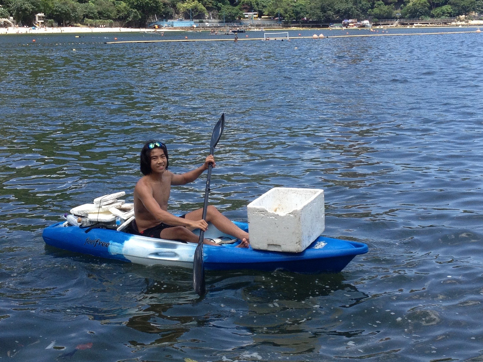 A young paddler collects plastic in Repulse Bay in an attempt to curb the pollution problem. Photo: Ocean Recovery Alliance