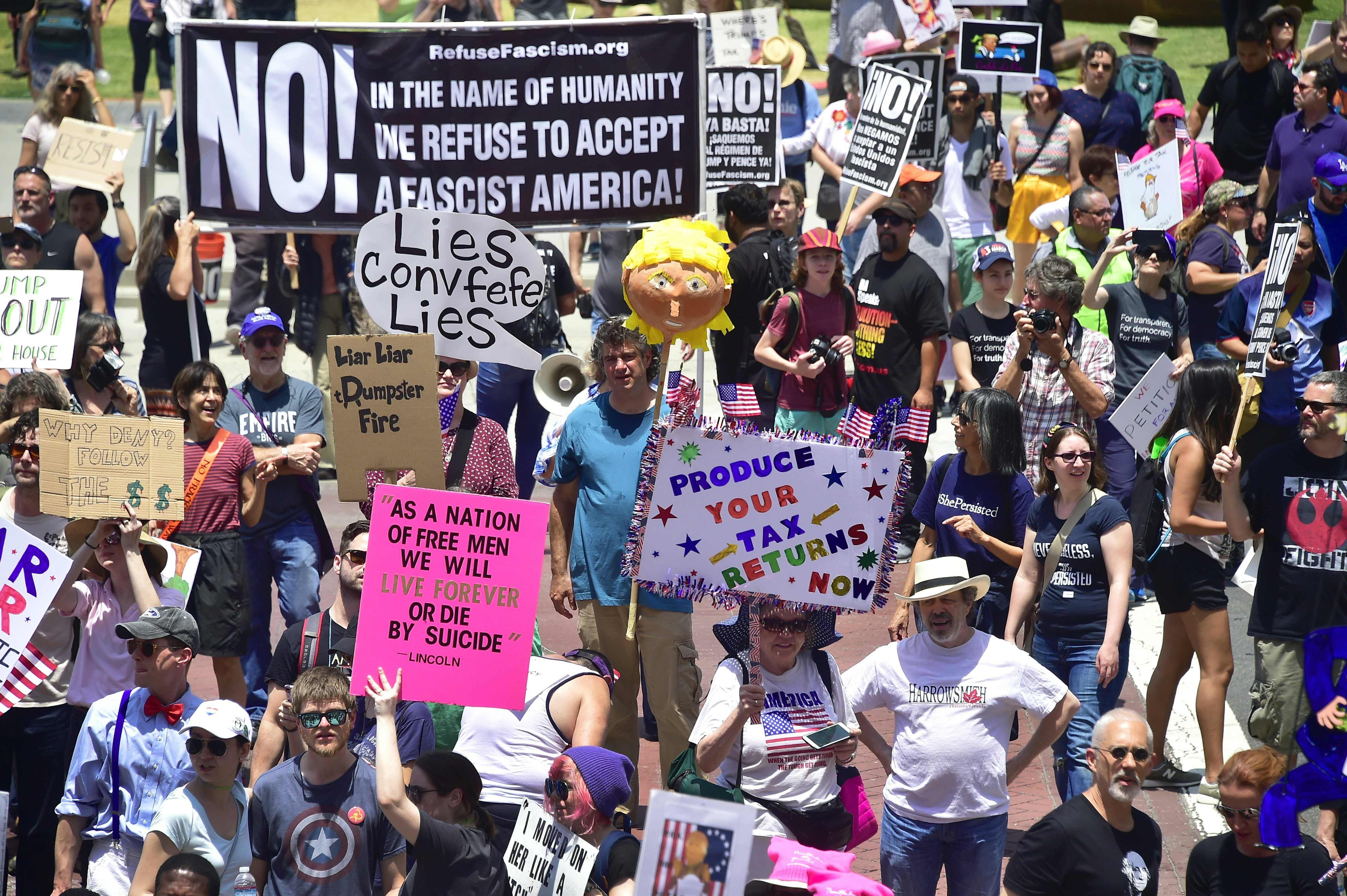 Placards convey many messages, none complimentary, to US President Donald Trump, as activists in California march to City Hall through downtown Los Angeles, on June 3. Photo: AFP