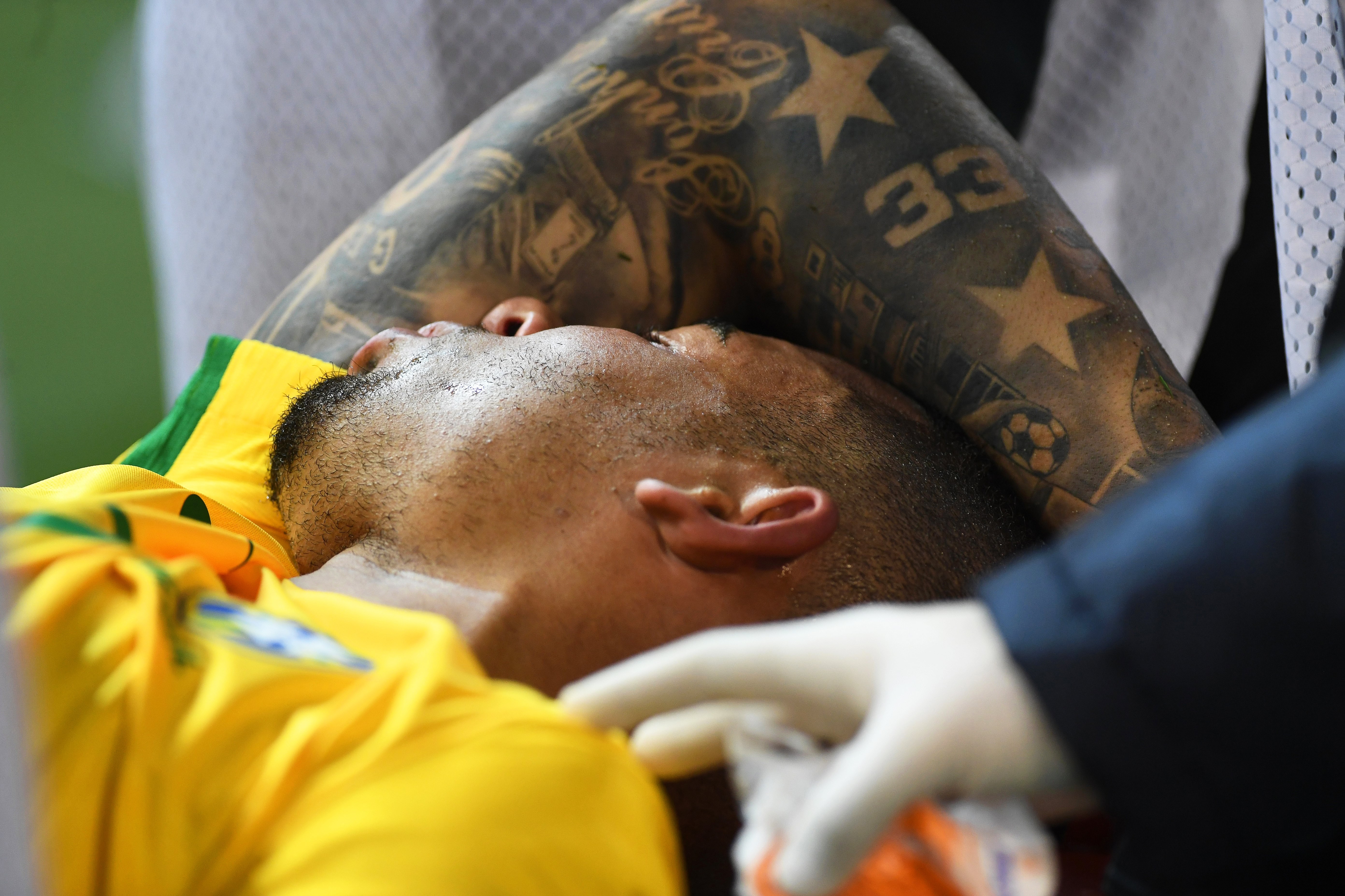 Gabriel Jesus is stretchered off the pitch after suffering a broken eye socket against Argentina in Melbourne. Photo: EPA