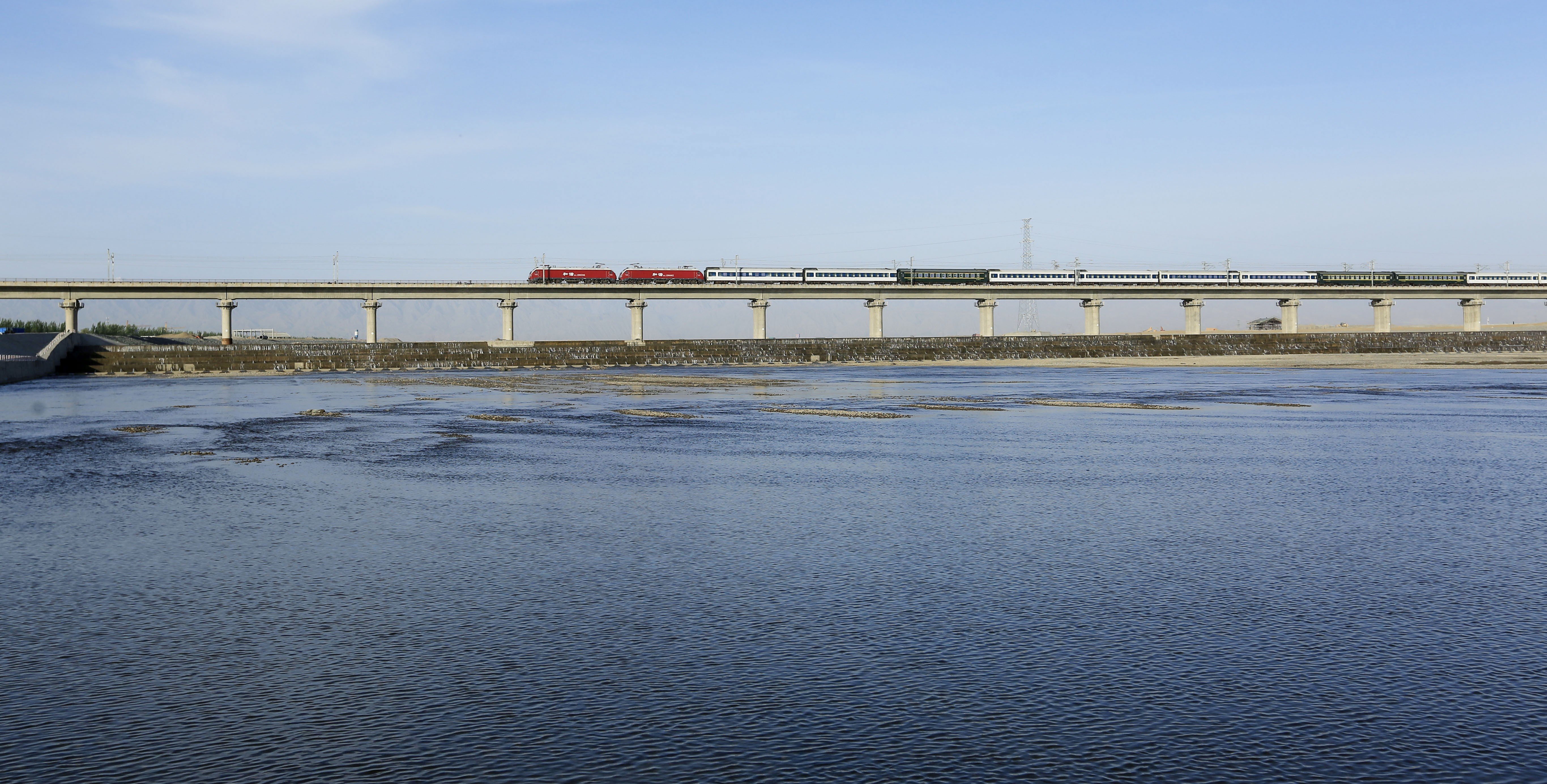A train along the Heihe Bridge of the Lanxin High-speed Railway in Zhangye City in Gansu province. The 1,776-kilometer railway linking Lanzhou, capital of Gansu, and Urumqi, capital of Xinjiang, is one of the major passages for China's Belt and Road Initiative. Photo: Xinhua
