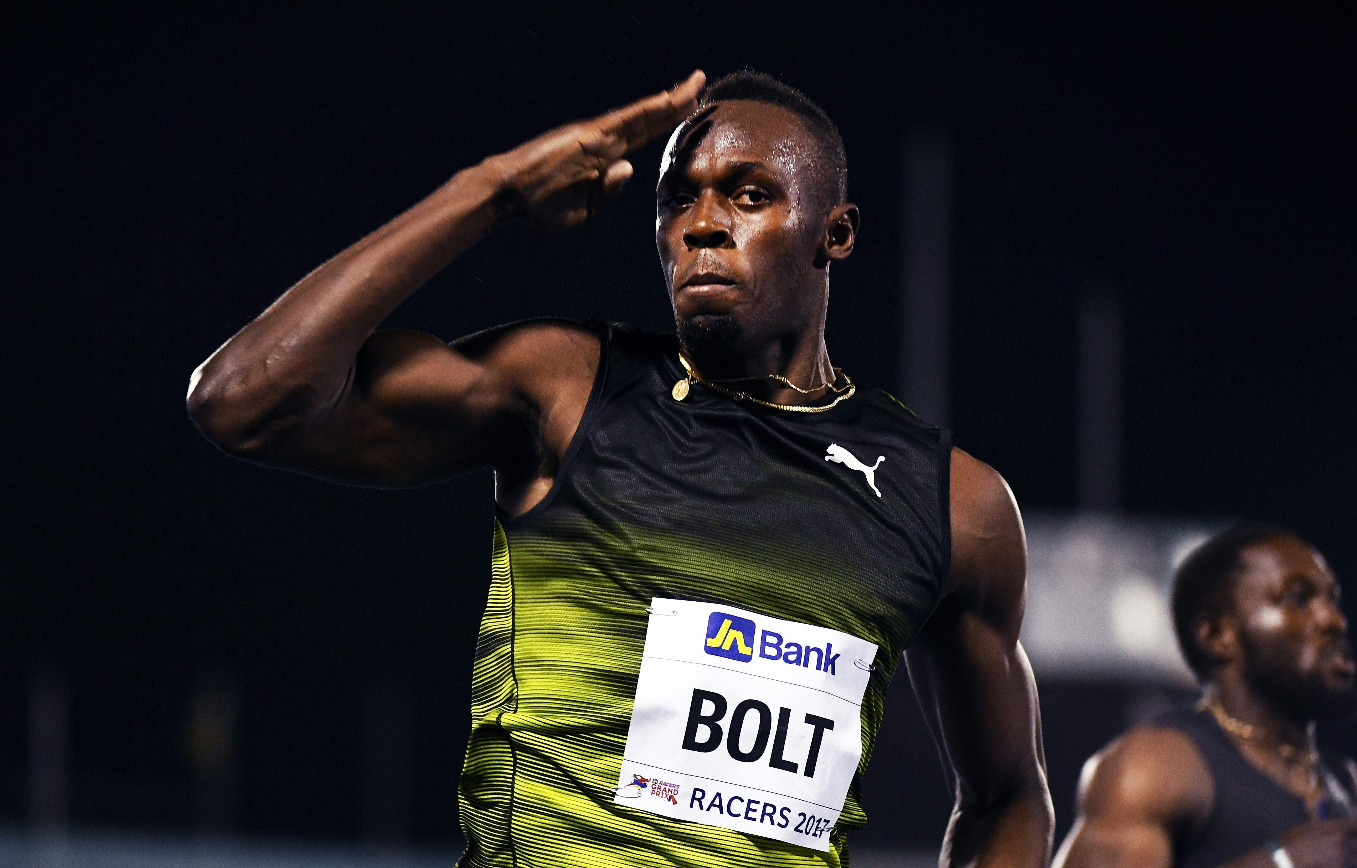 Usain Bolt salutes the crowd as he crosses the finish line of his final race in his home country. Photo: AFP