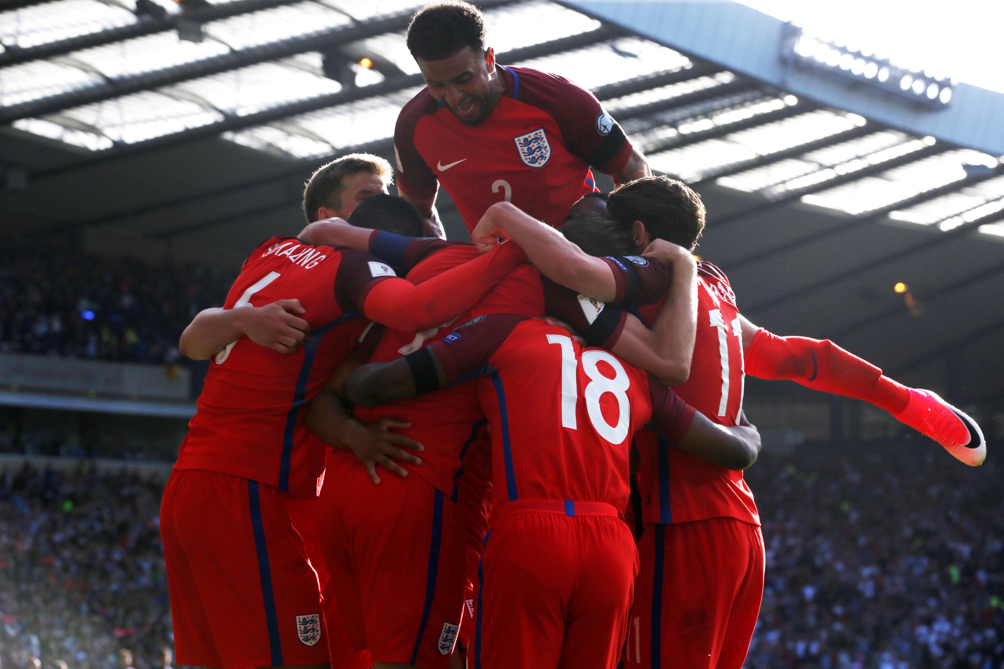 England’s Harry Kane is mobbed by teammates after netting a late equaliser. Photo: Reuters