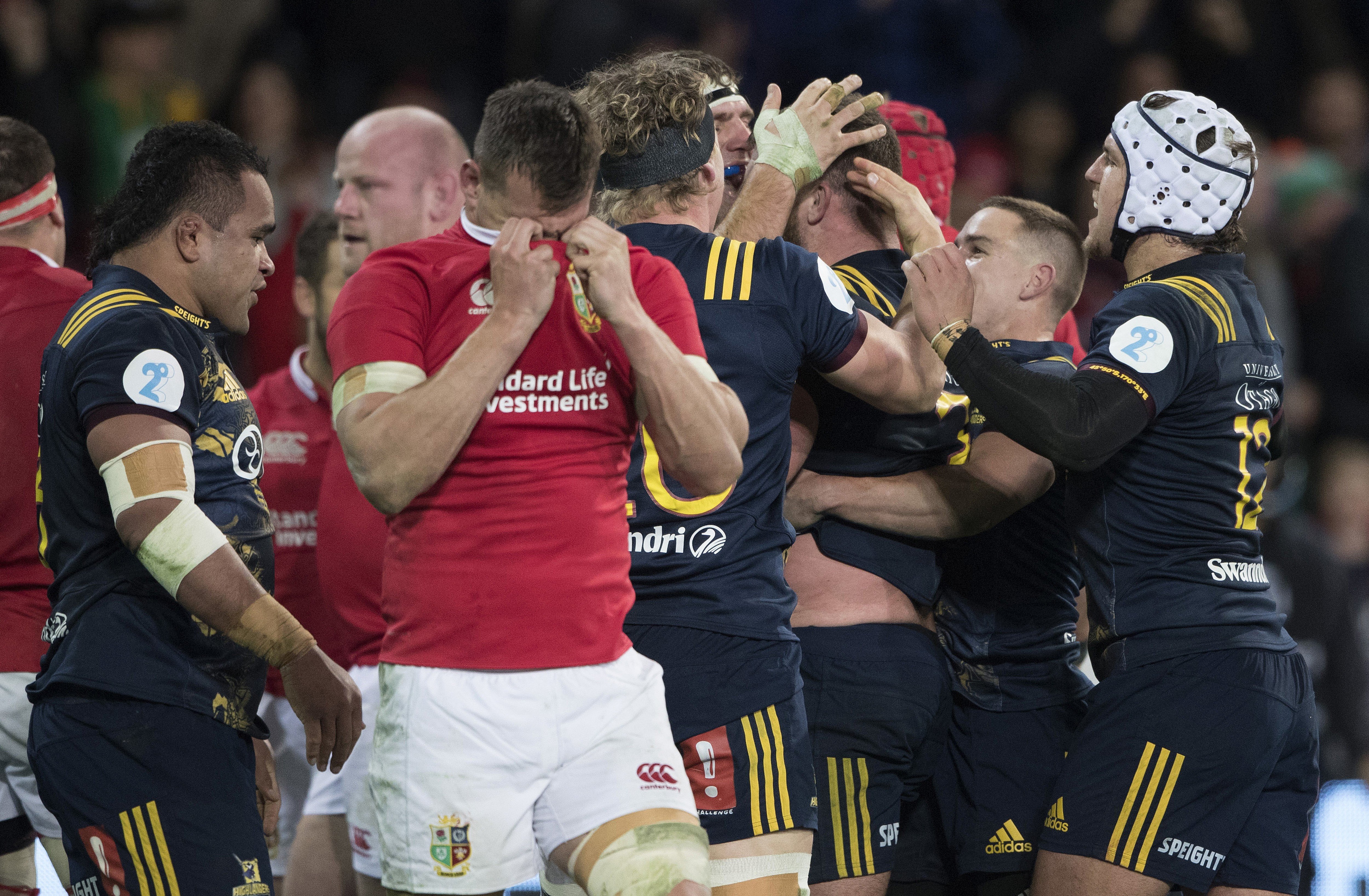 Lions captain Sam Warburton wipes his face as the Highlanders celebrate a try in their nail-biting victory in Dunedin. Photo: AP