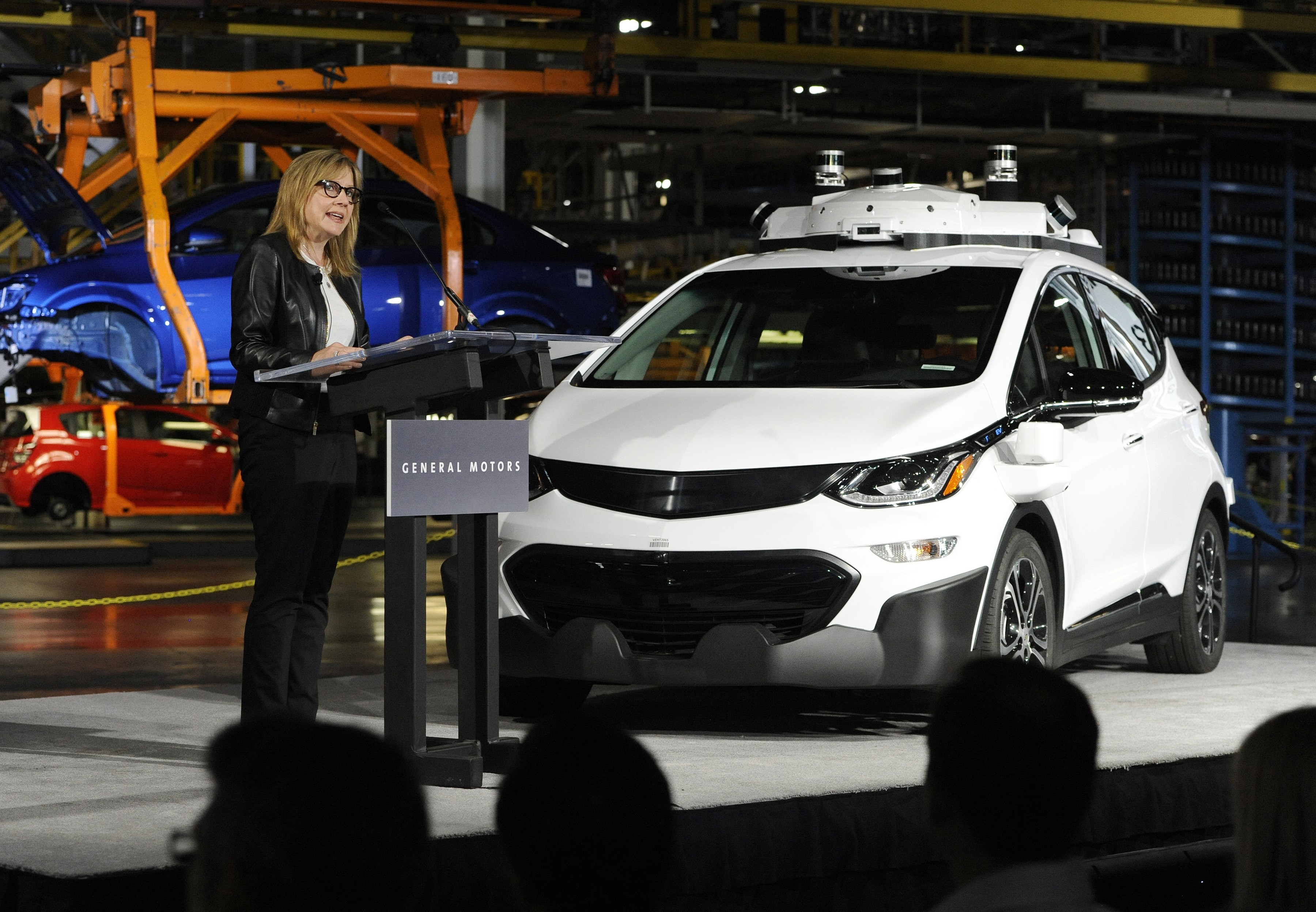 General Motors chair and CEO Mary Barra stands next to a self-driving Chevrolet as she gives updates about the company’s autonomous vehicle development programme, in Michigan on June 13. Photo: AP