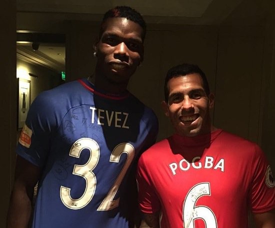 Carlos Tevez poses in Manchester United shirt