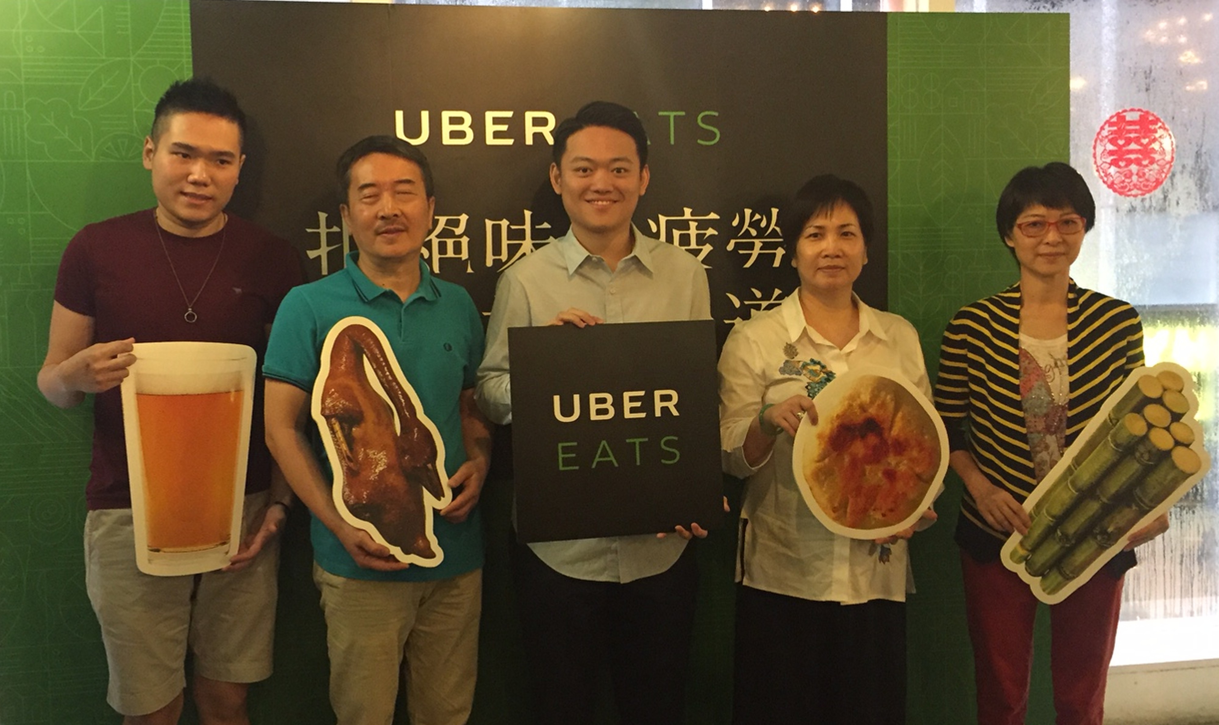 Horace Lam, general manager of UberEats (centre), surrounded by local food vendors who have signed up for the company’s delivery services. Photo: Handout