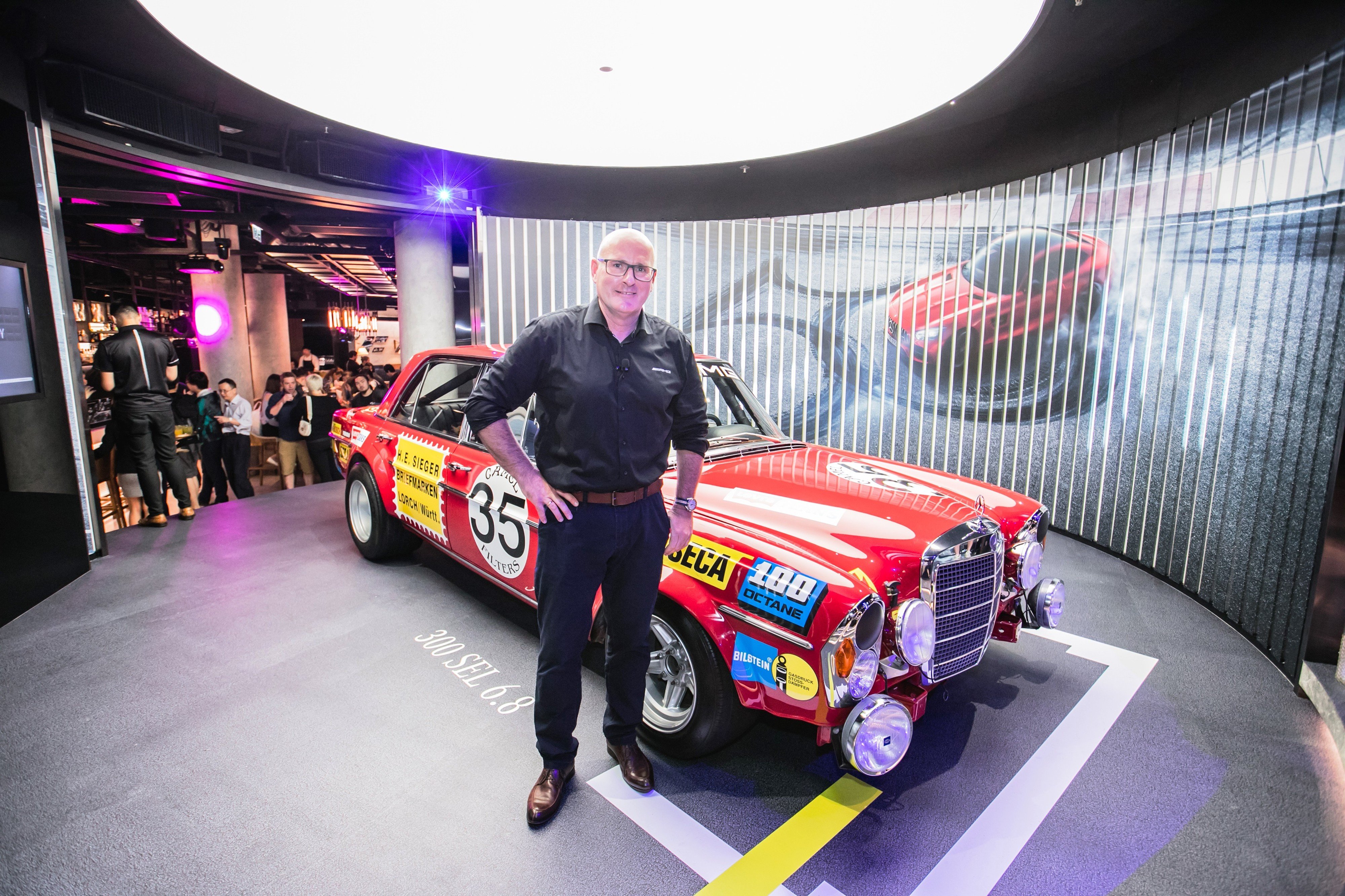 Mercedes-AMG product manager Joerg Letzel with the 1971 AMG 300 SEL 6.8 'Red Giant' at Mercedes Me, Central. Photo: Handout
