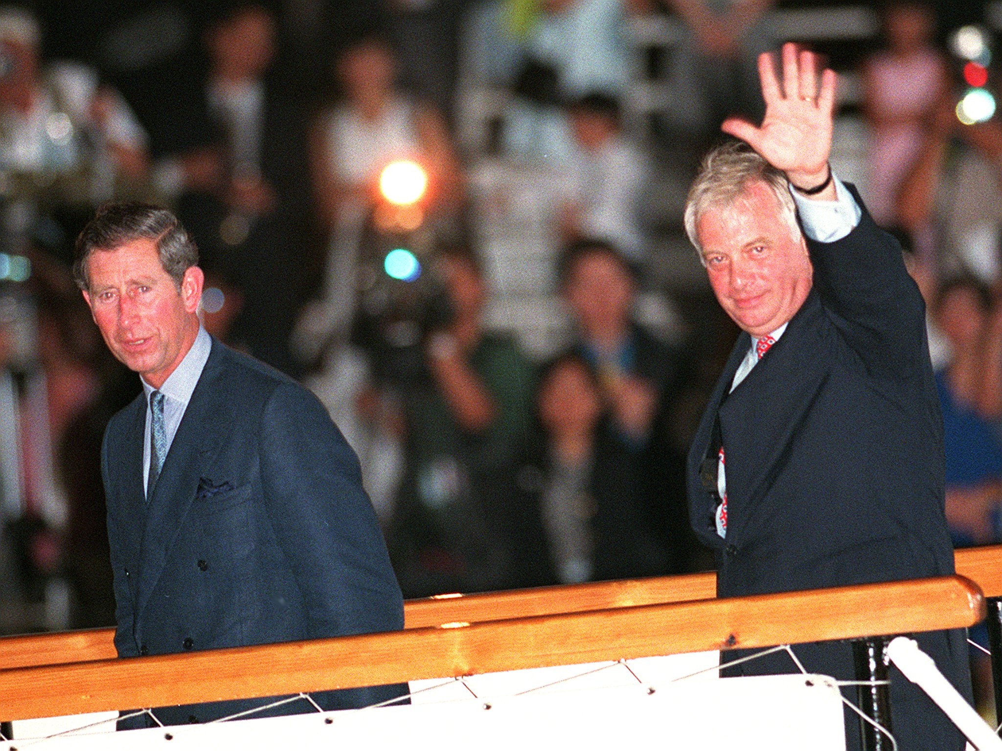 Hong Kong’s last governor Chris Patten (right) waves to well-wishers as he boards the Royal Yacht Britannia accompanied by Prince Charles prior to their departure from Hong Kong. Photo: AFP Romeo Gacad