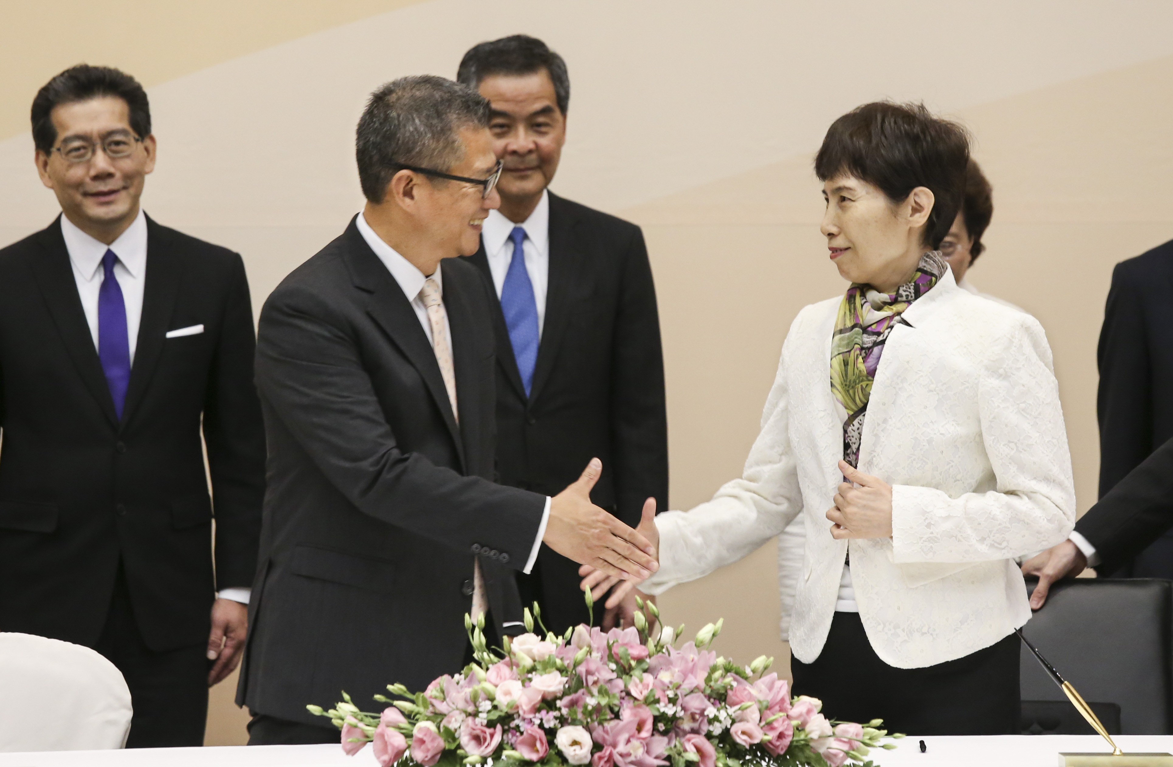 Financial Secretary Paul Chan Mo-po (left) shakes hands with the central government’s commerce undersecretary Gao Yan (right) at Tamar on Wednesday. Photo: Dickson Lee