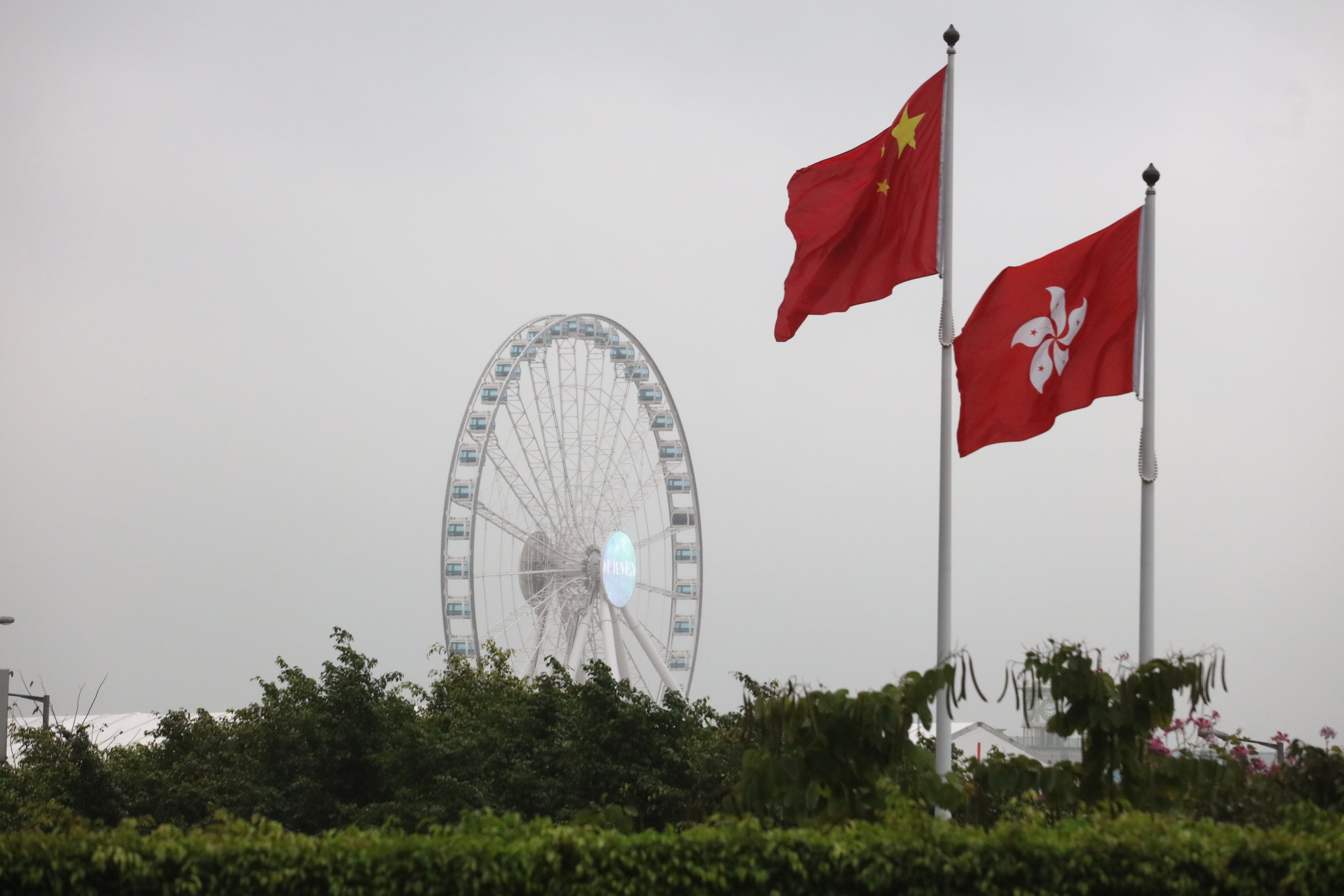 The China (left) and Hong Kong flags fly over Victoria Harbour in Hong Kong. Photo: Felix Wong