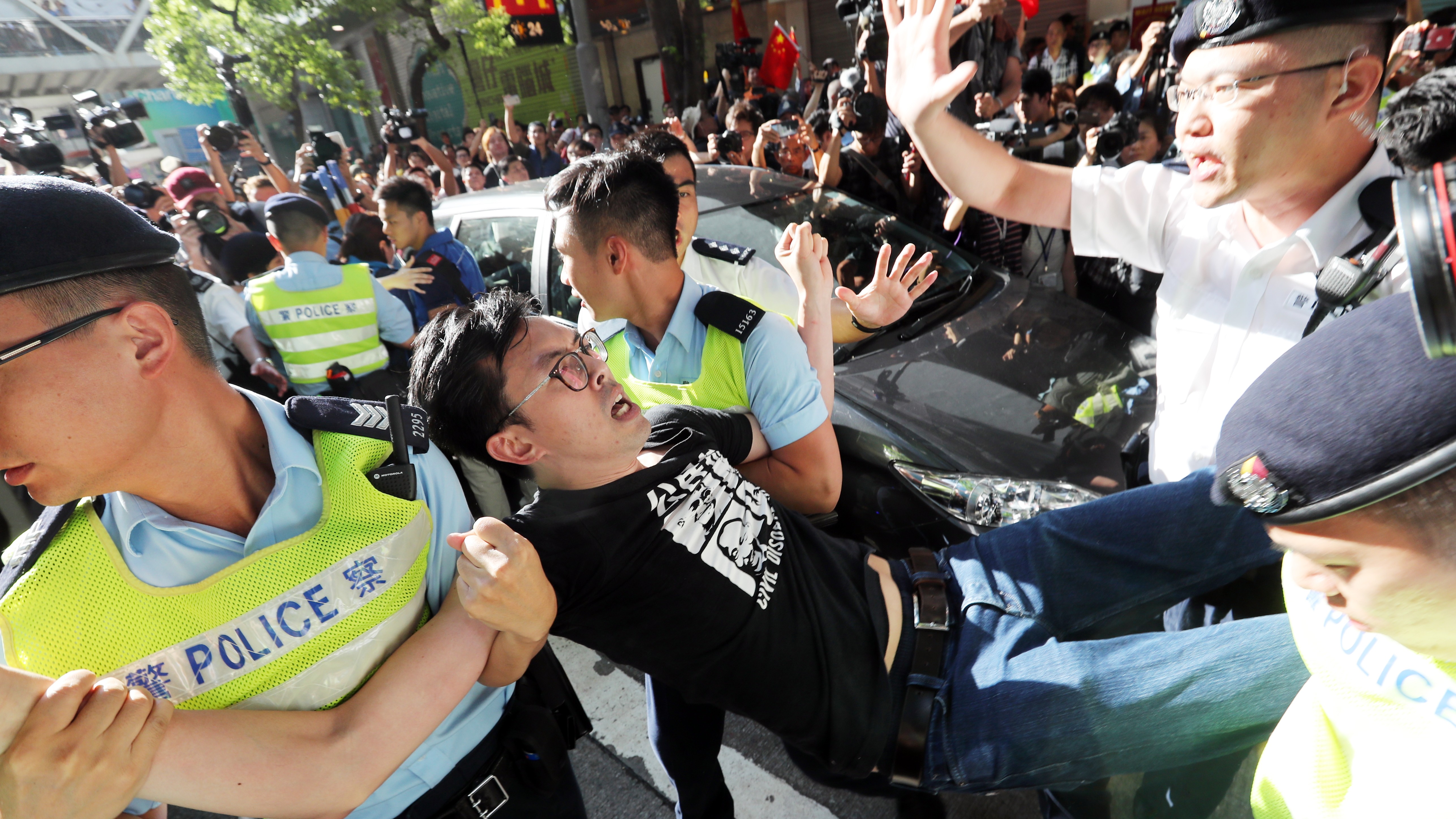 Police officers detain League of Social Demarcates chairman Avery Ng Man-yuen during a protest near the flag raising ceremony at Golden Bauhinia Square. Photo: Edward Wong