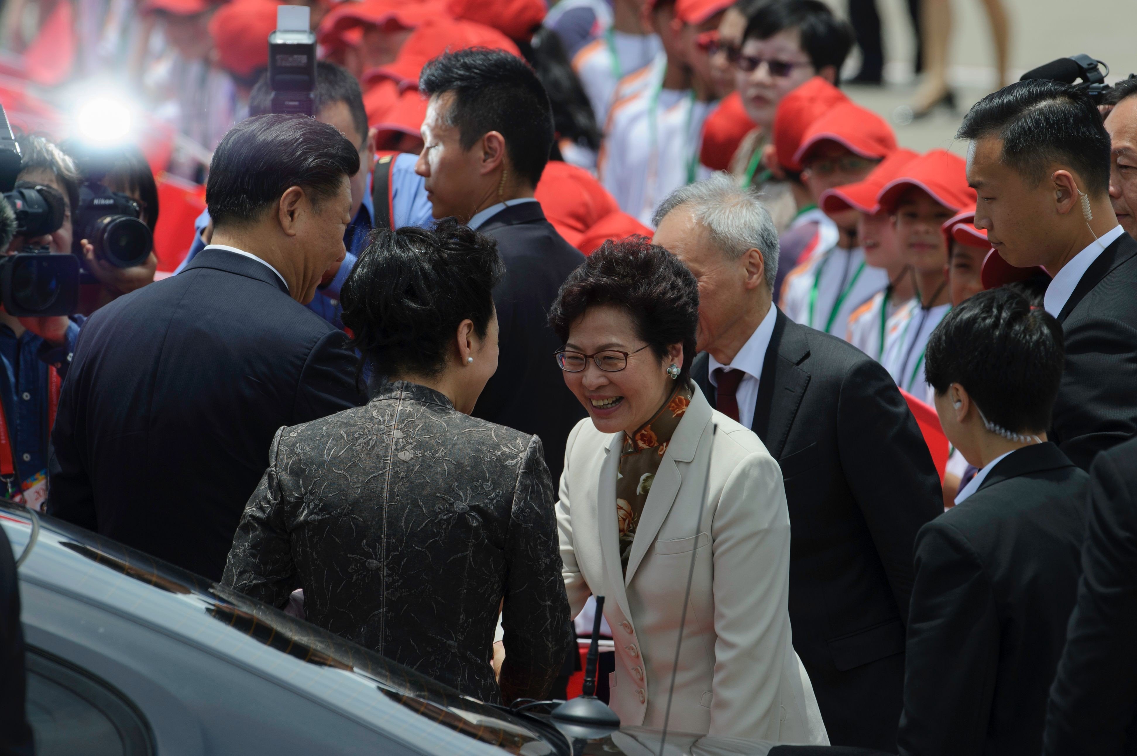 New Chief Executive Carrie Lam shakes hands with Peng Liyuan at the airport shortly before the first lady’s departure for Beijing. Photo: AFP