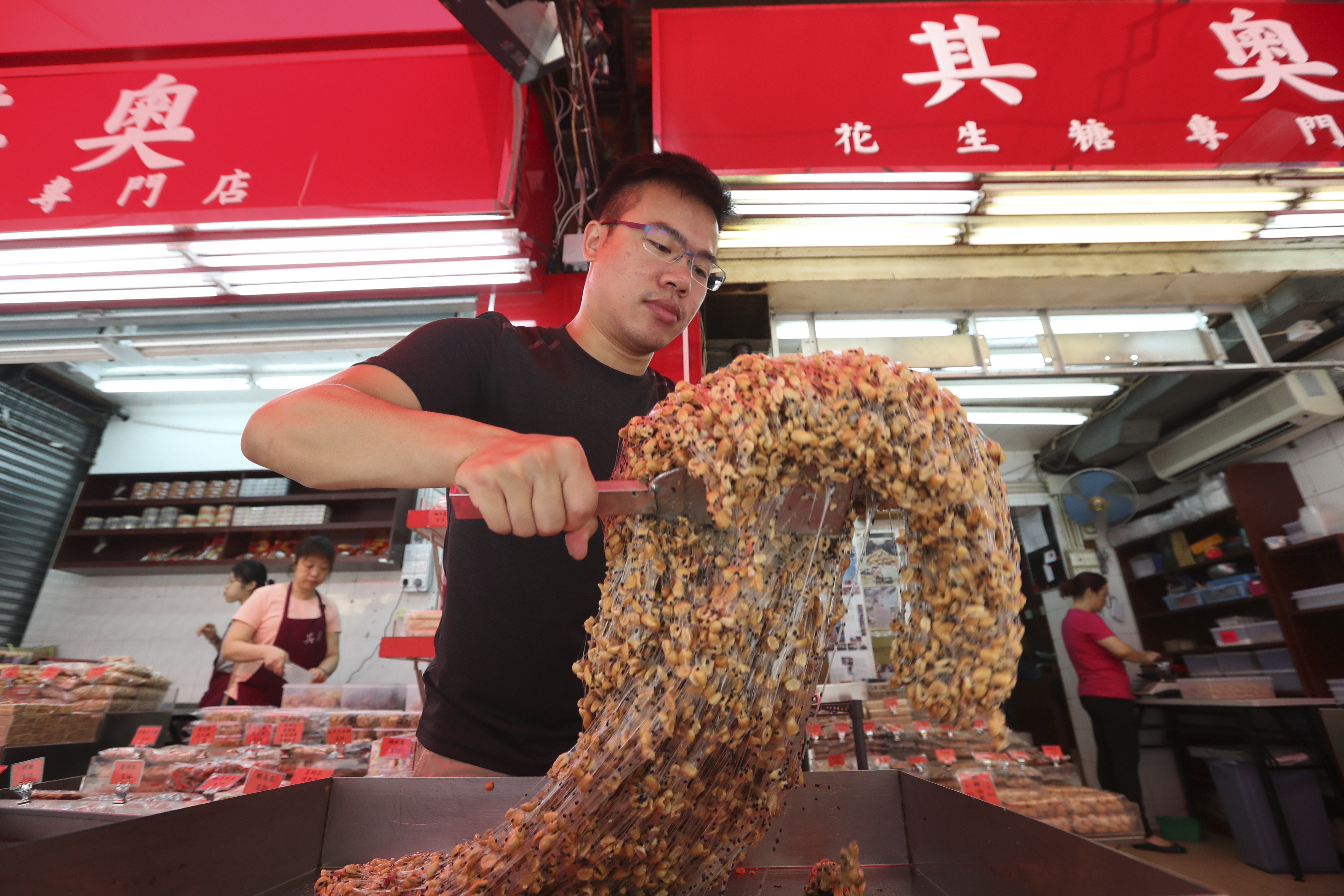 Jason Wong and his family make candy at Kei O in Yuen Long. Pictures: Nora Tam