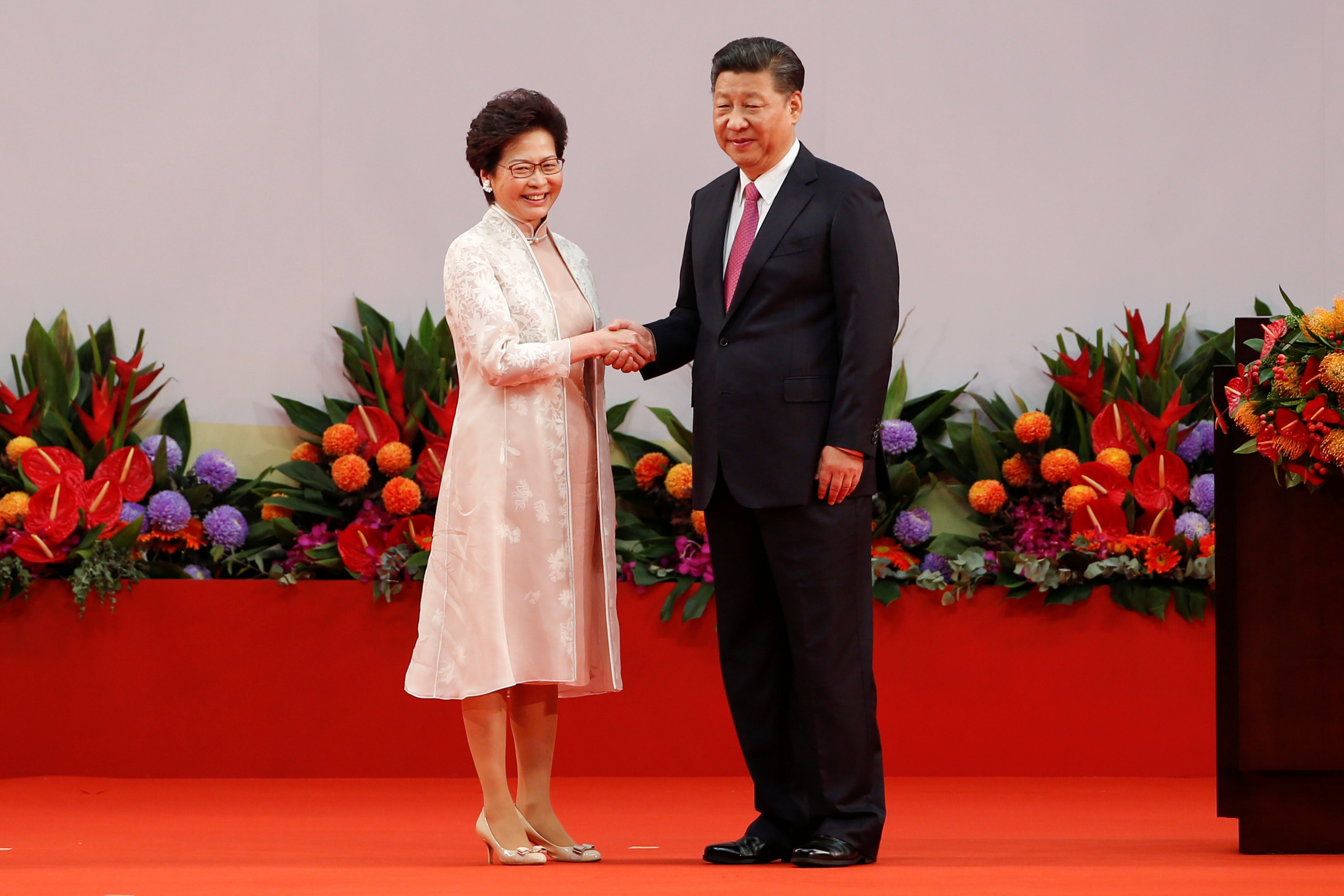 A resplendent Carrie Lam shakes hands with President Xi Jinping after being sworn in as chief executive. Photo: Reuters