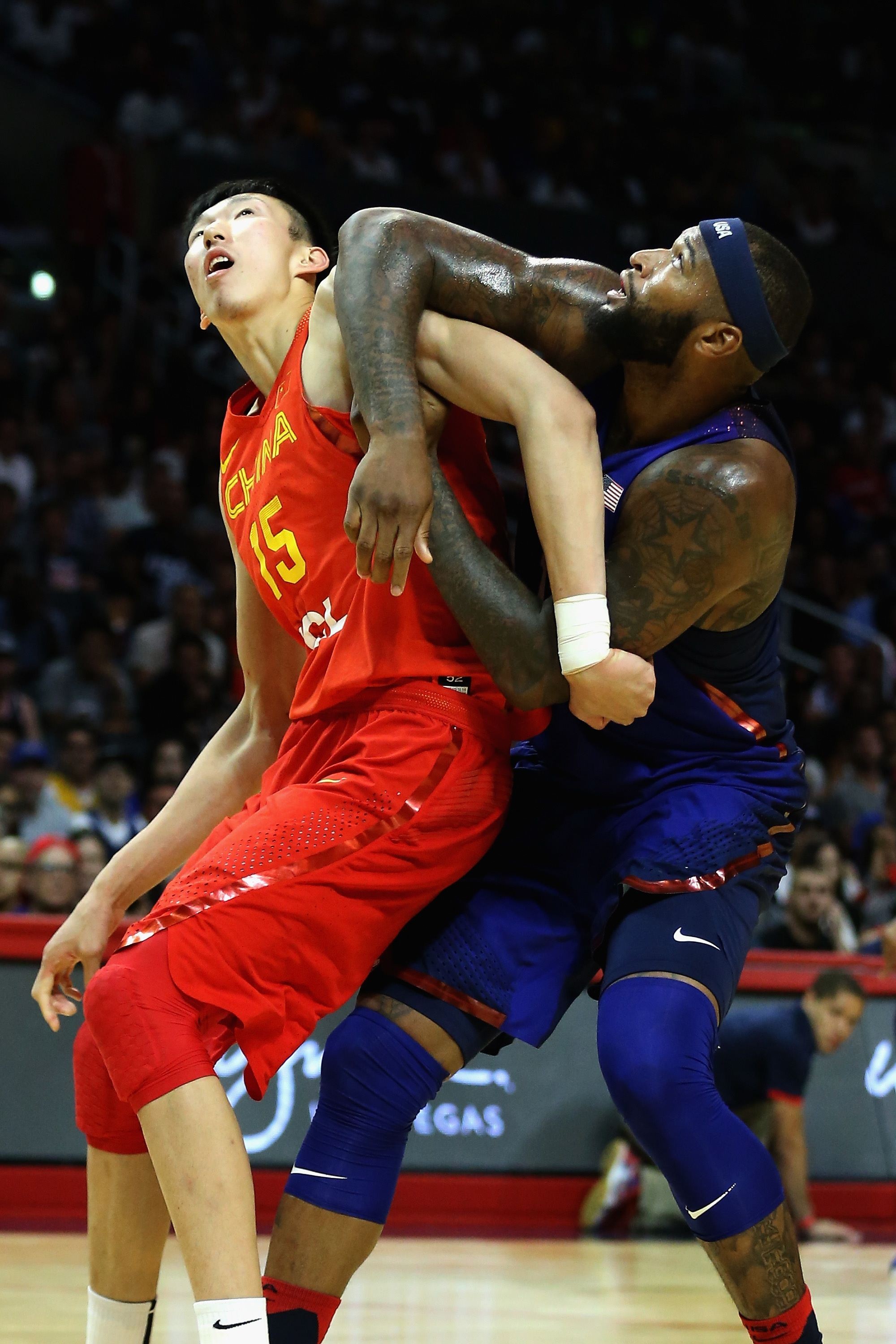Zhou Qi wrestles with DaMarcus Cousins during an exhibition game between China and the USA before last summer’s Olympics. Photo: AFP 