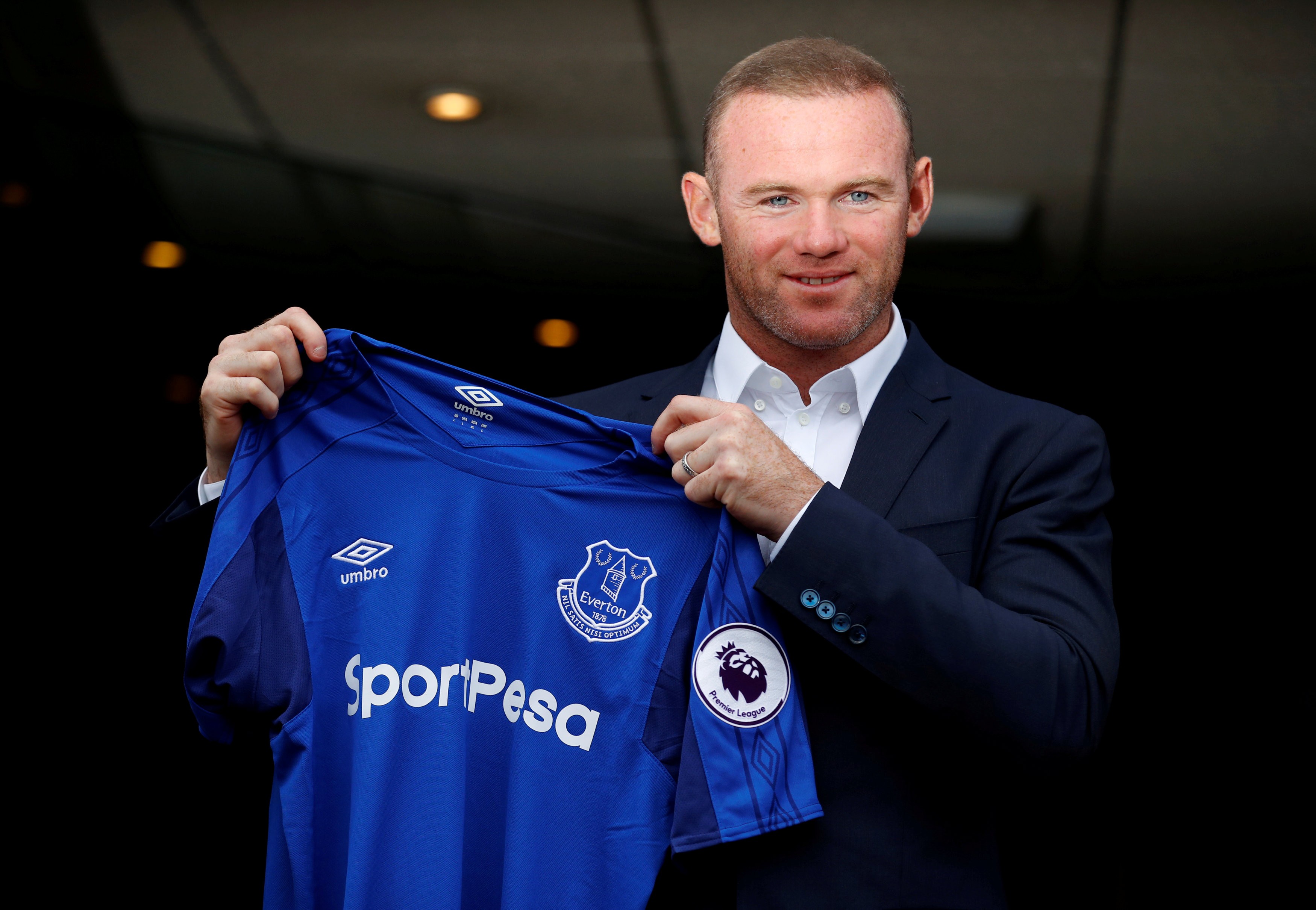 Everton's Wayne Rooney poses with the club shirt. Photo: Reuters