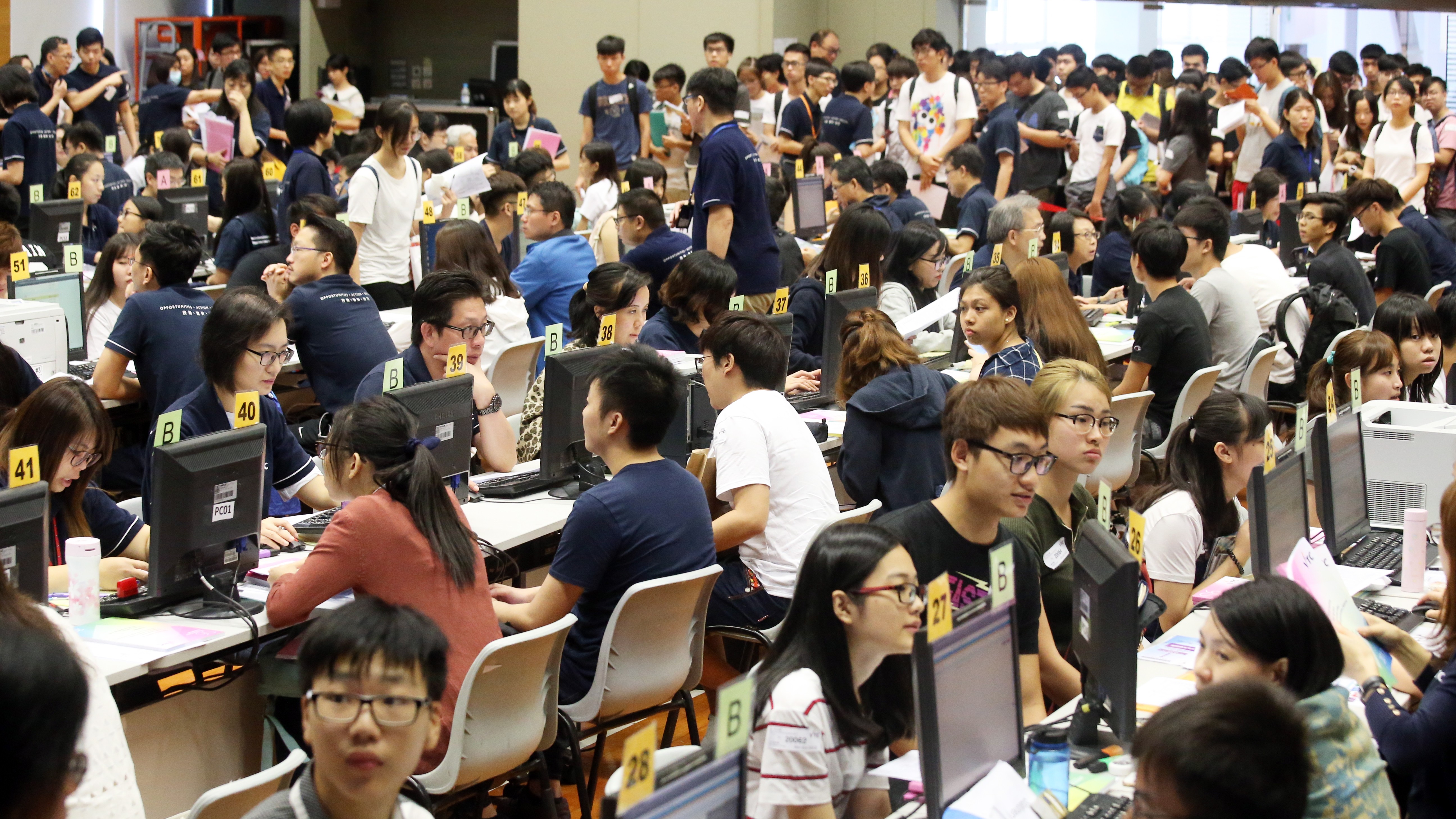 DSE students applying for self-financing degrees in Cheung Sha Wan on Wednesday. Photo: K. Y. Cheng