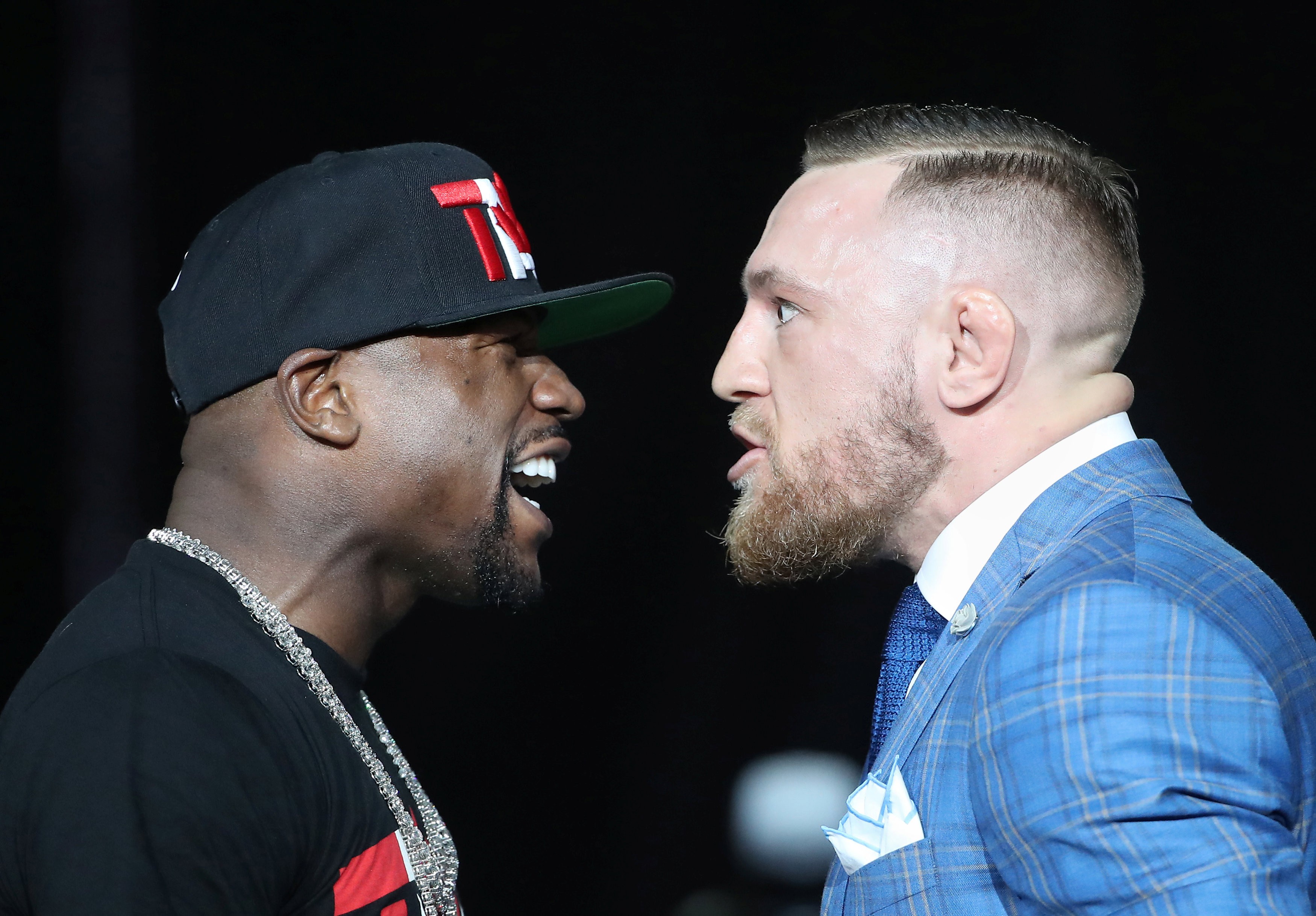 Floyd Mayweather and Conor McGregor stare each other down during their world tour press conference. Photo: USA Today