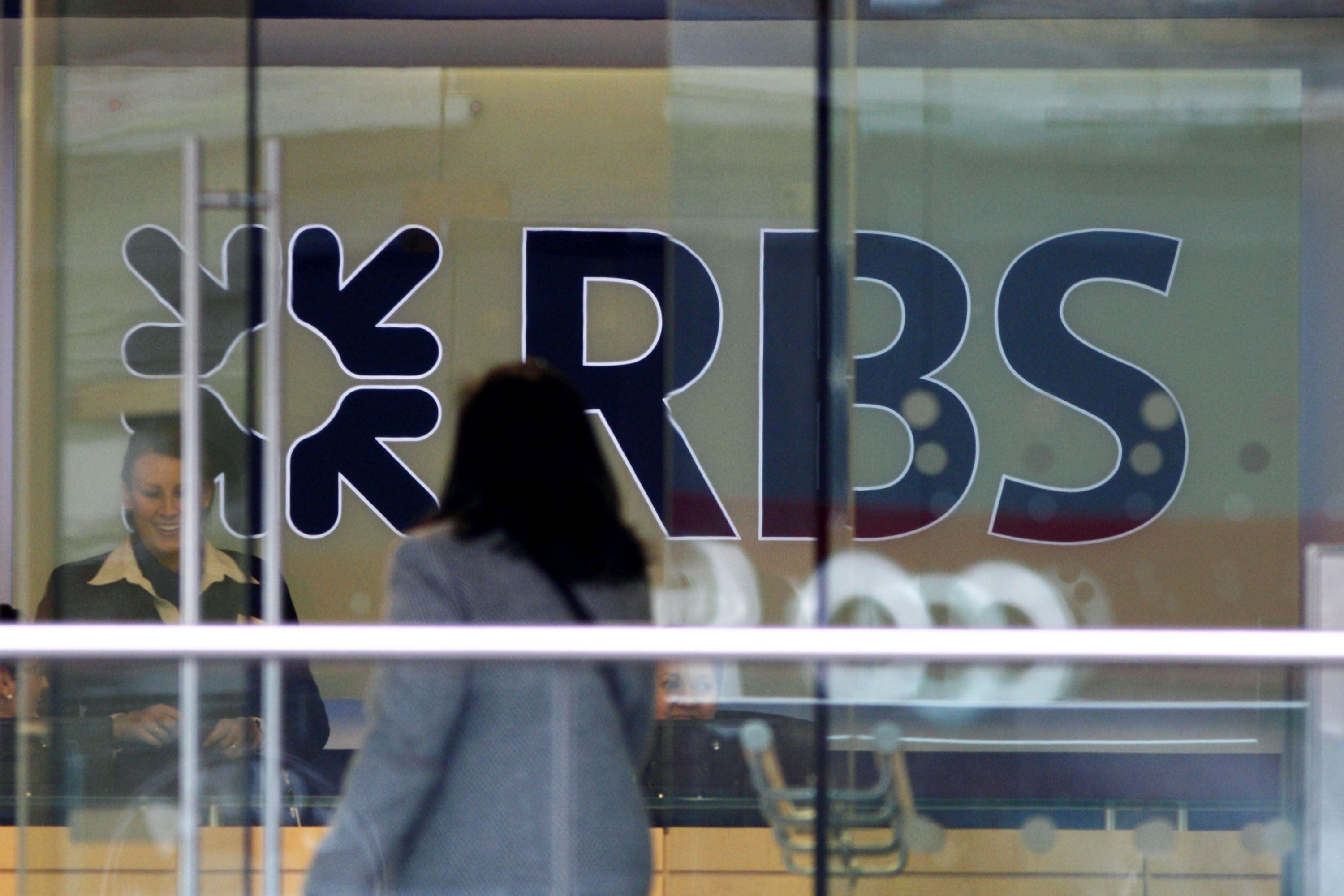 A customer walks into a branch of the Royal Bank of Scotland building in London. The bank is paying a settlement for mis-selling mortgage backed securities in the US going back to the global financial crisis. Photo: AFP