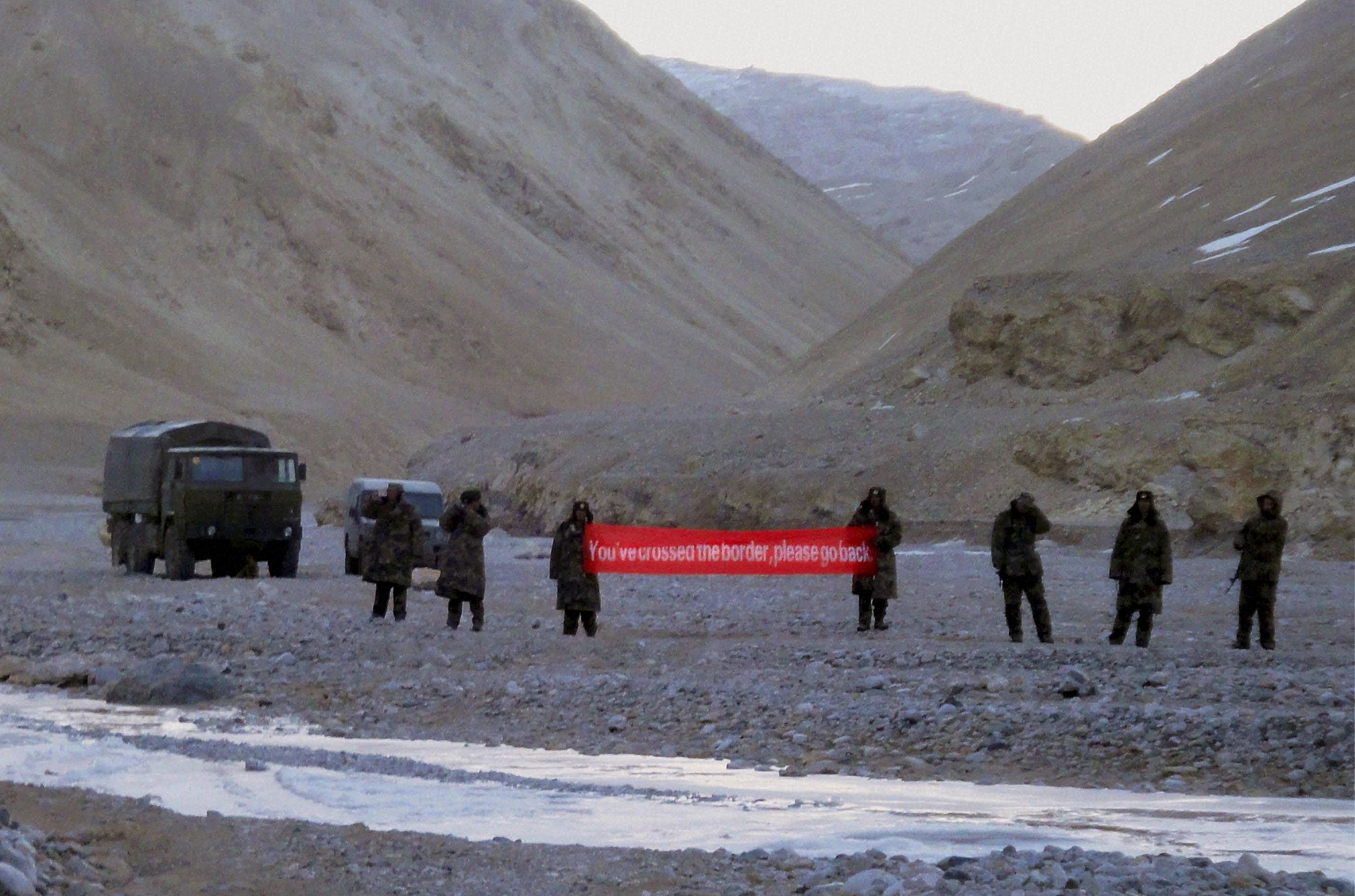 Chinese troops hold a banner which reads “You’ve crossed the border, please go back” in Ladakh, India, in May 2013. Border disputes between the two countries, arguably a result of British colonisation, have simmered for years but recently flared up again. Photo: AP