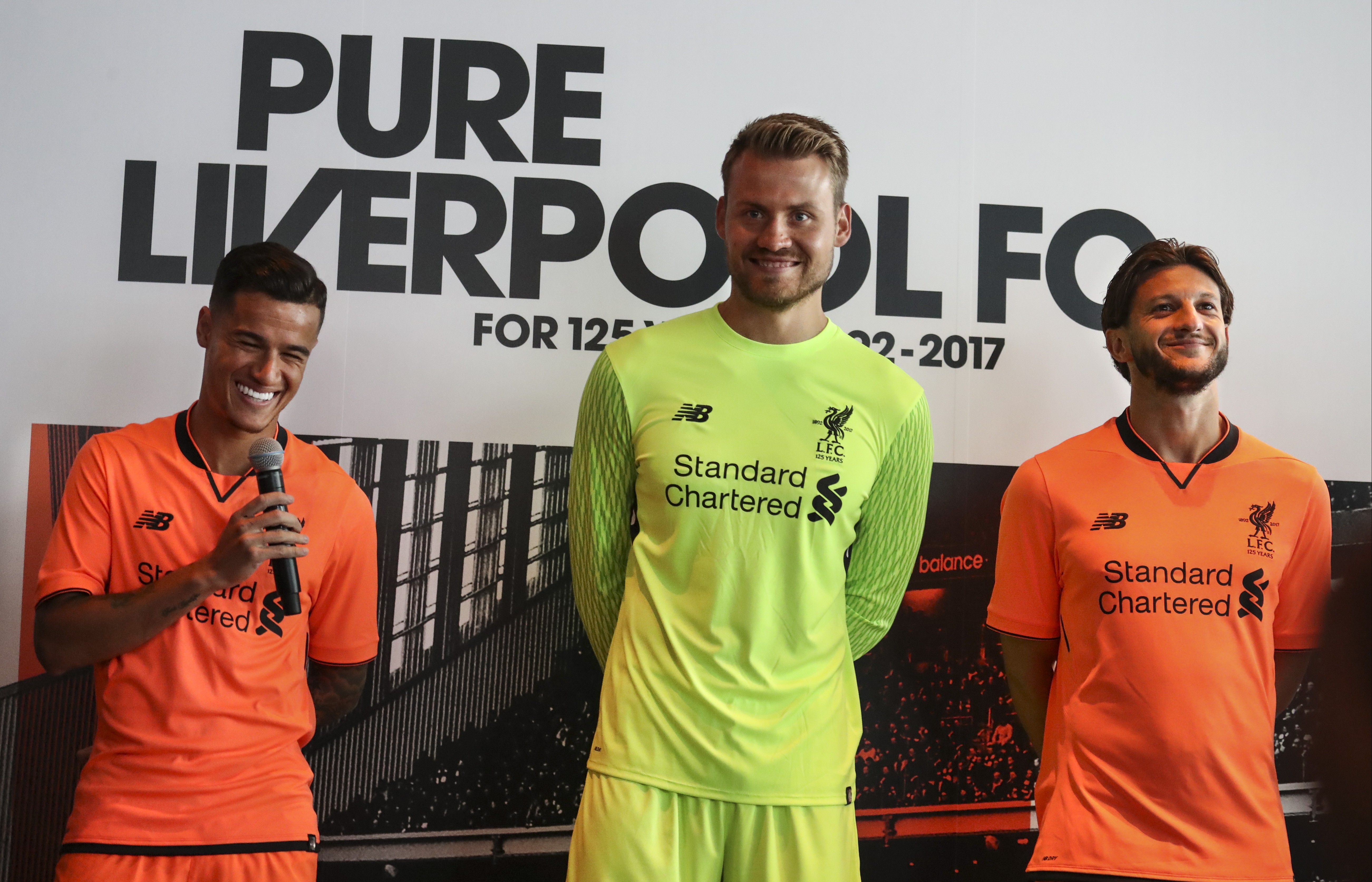Philippe Coutinho (left), Simon Mignolet and Adam Lallana model Liverpool’s new third kit during a promotional event at the Ozone Bar. Photo: Nora Tam