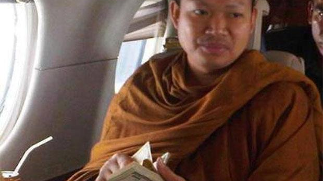 One of the early photos revealing then-monk Luang Pu Nem Kham, flaunting US currency while flying in a private jet. Photo: Facebook