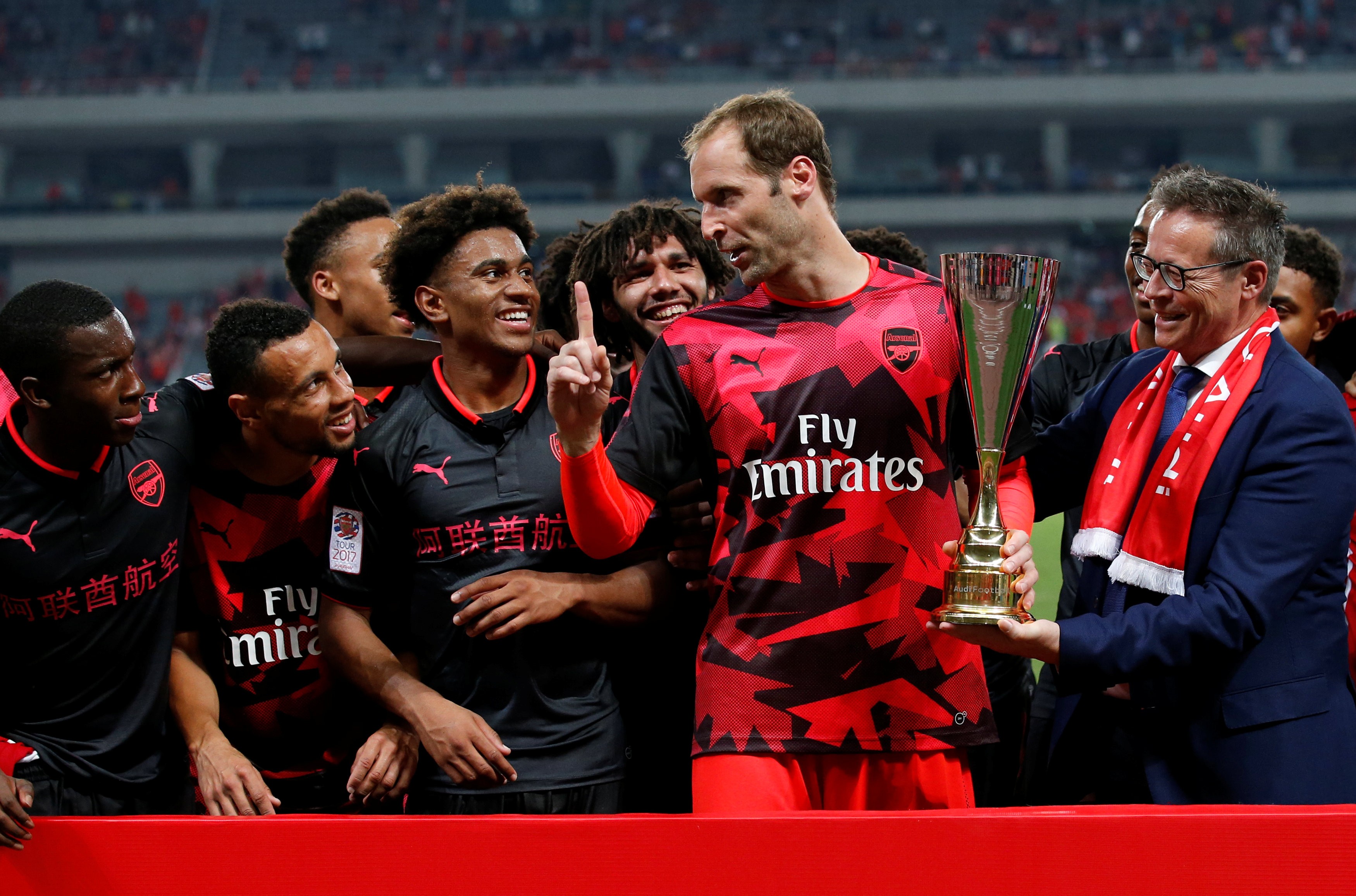 Arsenal's Petr Cech celebrates with the trophy and his teammates after the match. Photo: Reuters