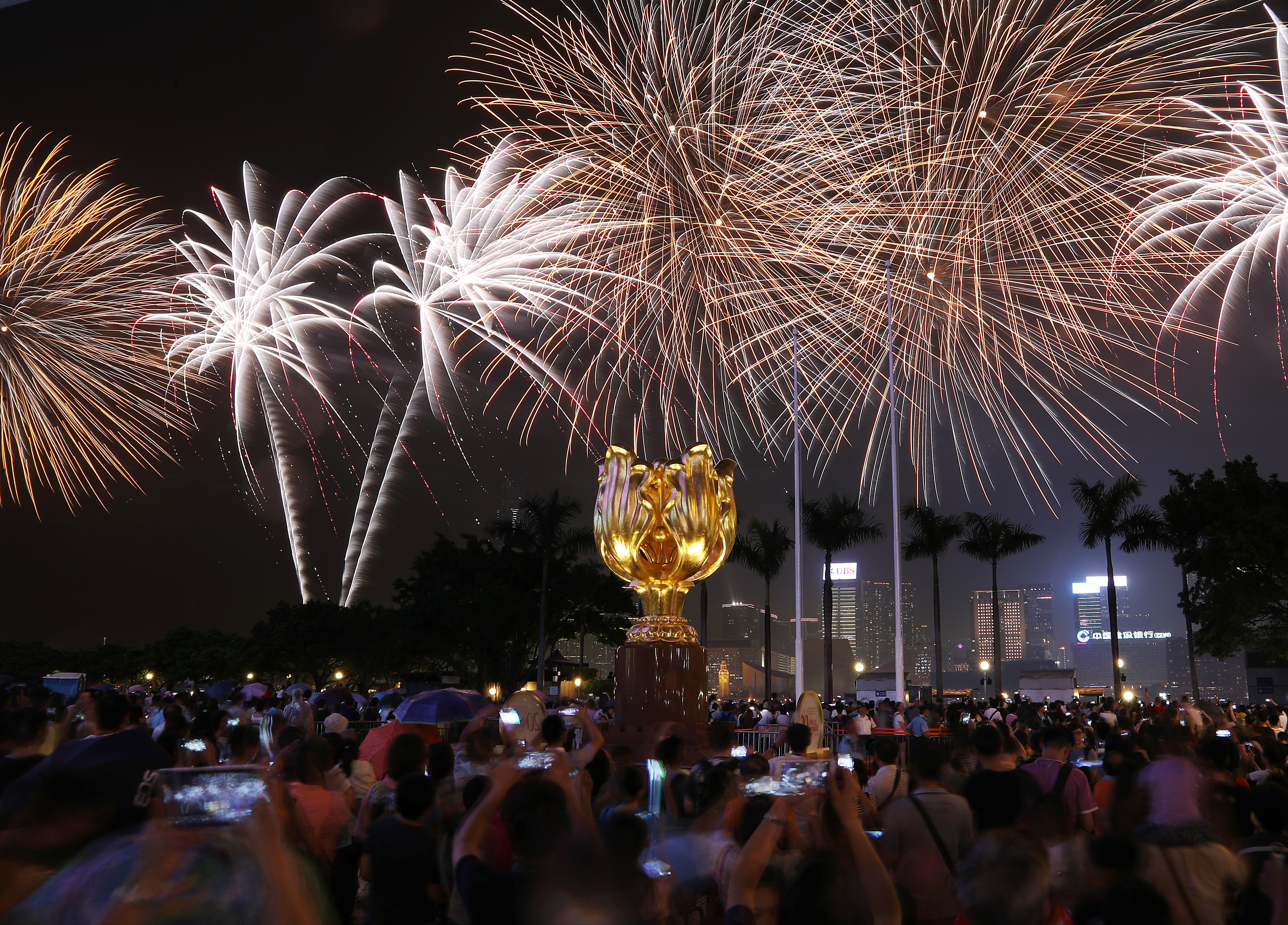 Fireworks explode over Victoria Harbour and the Golden Bauhinia as Hong Kong celebrates the 20th anniversary of its handover, on July 1. Nora Tam