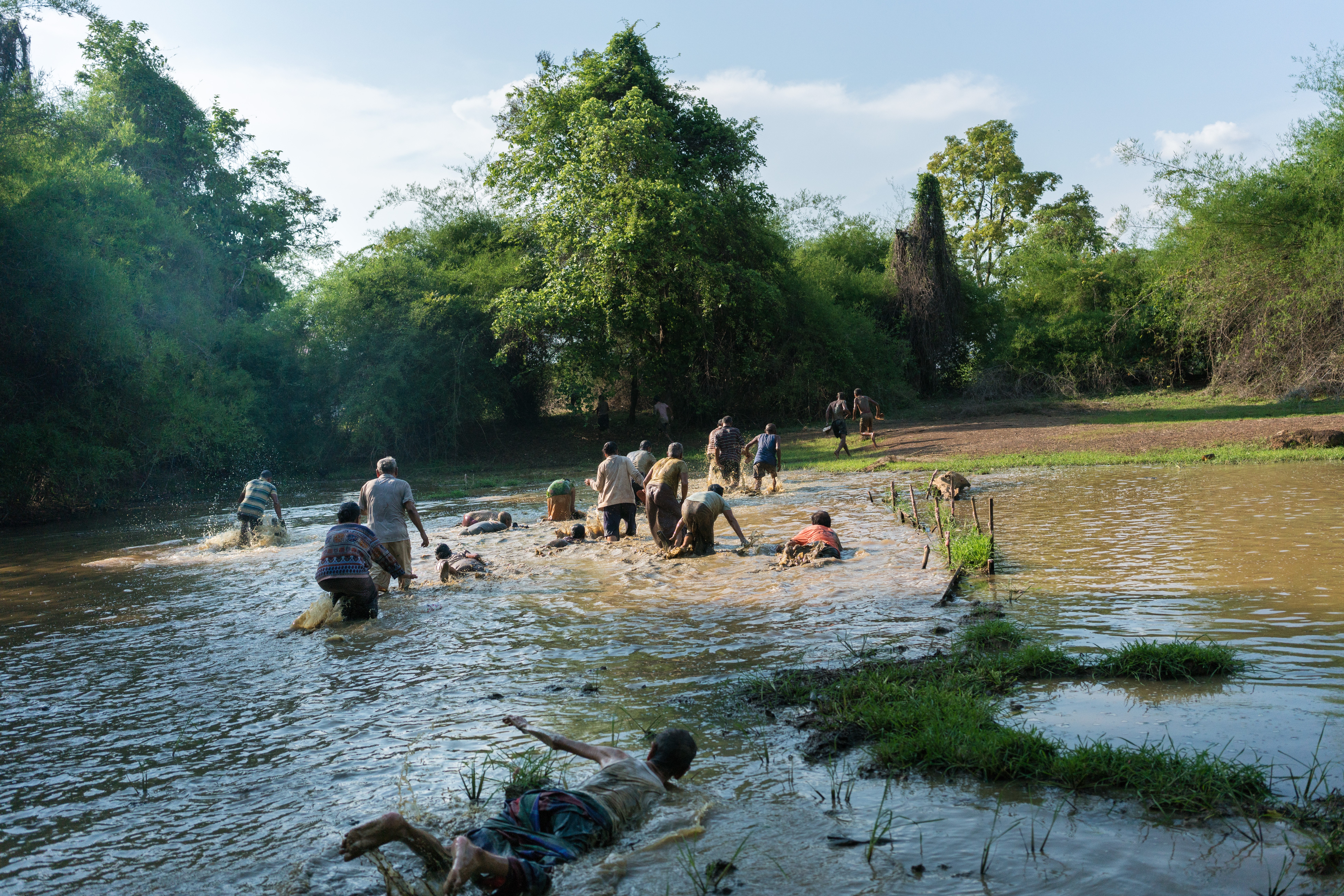 As part of a ritual to draw out the evil spirit known as Phi Pob, those accused of being possessed must crawl through a pond and cover themselves in mud before bathing in the Mekong. Pictures: Thomas Cristofoletti