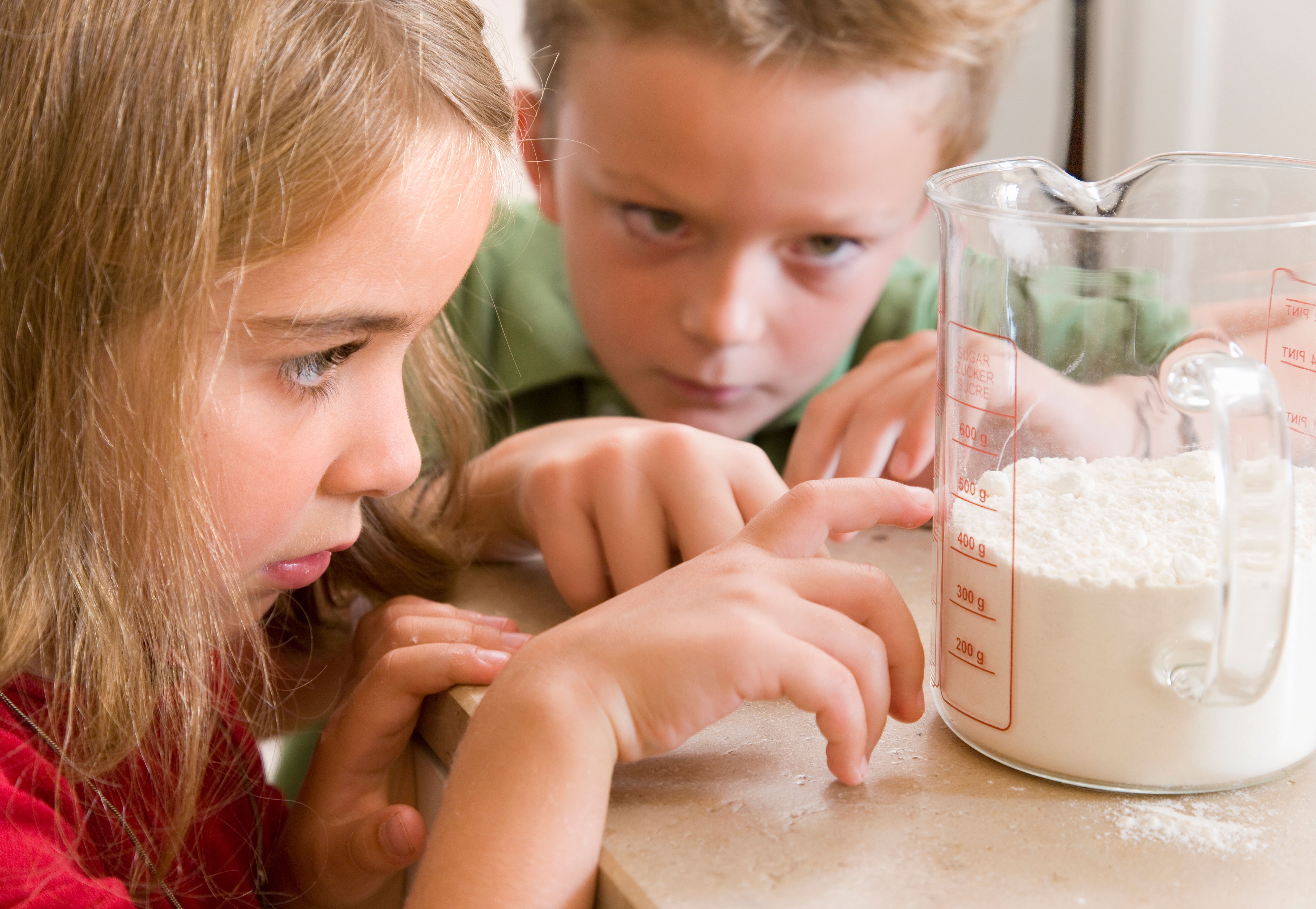 Find creative ways to keep maths in a child’s mind over the summer holiday, such as measuring flour for baking. Photo: Alamy