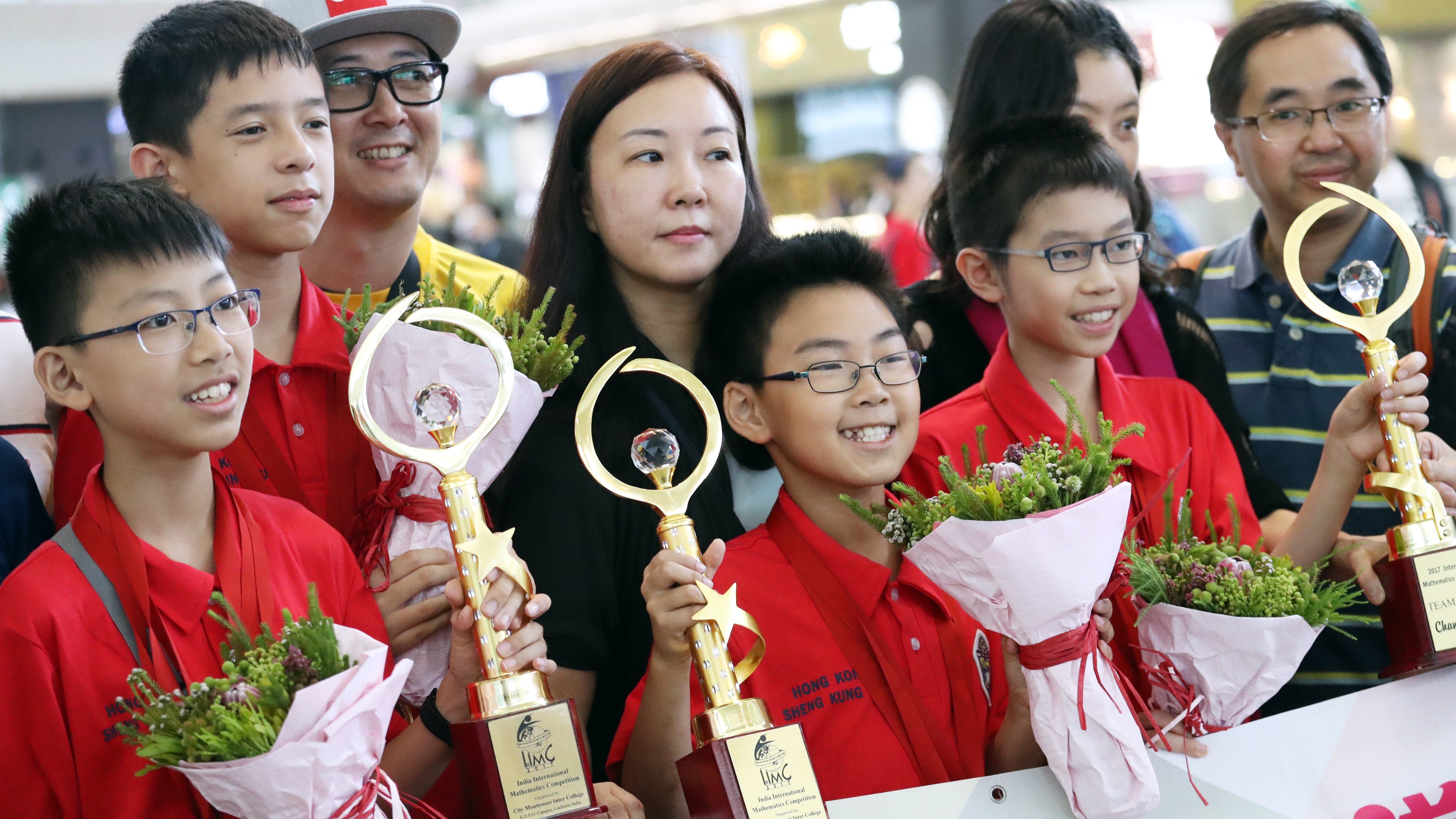 Winning team members Wong Ping-kuen, Rex Lo Chung-hei, Yiu Chun-hei and Chu Cheuk-hei (from left in red) display their trophies. Photo: Nora Tam