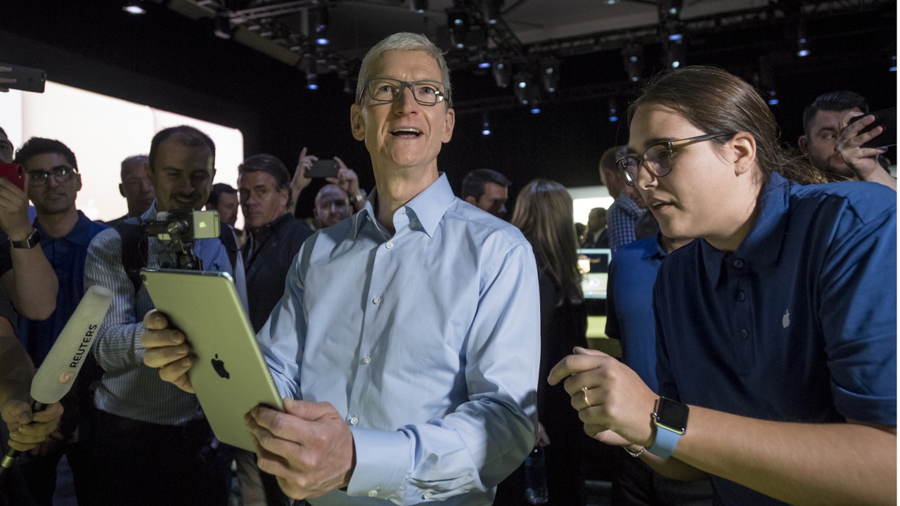 Tim Cook, chief executive officer of Apple Inc., center left, speaks to attendees while holding an iPad Pro during the Apple Worldwide Developers Conference (WWDC) in San Jose, California. Photo: David Paul Morris/Bloomberg