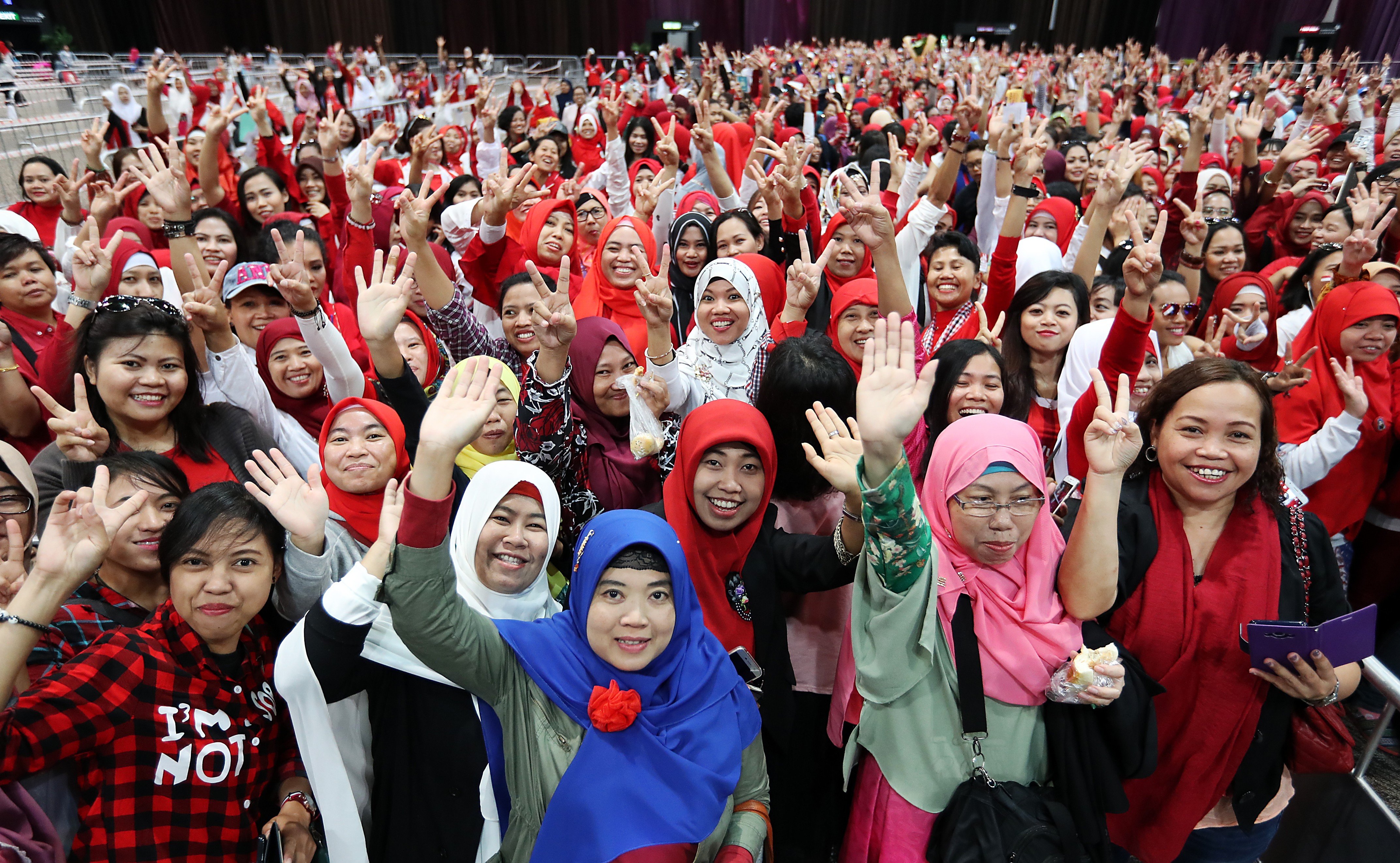 Indonesian domestic workers cheer at an event to meet visiting President Joko Widodo, at Hong Kong’s AsiaWorld Expo on April 30. Photo: Edward Wong