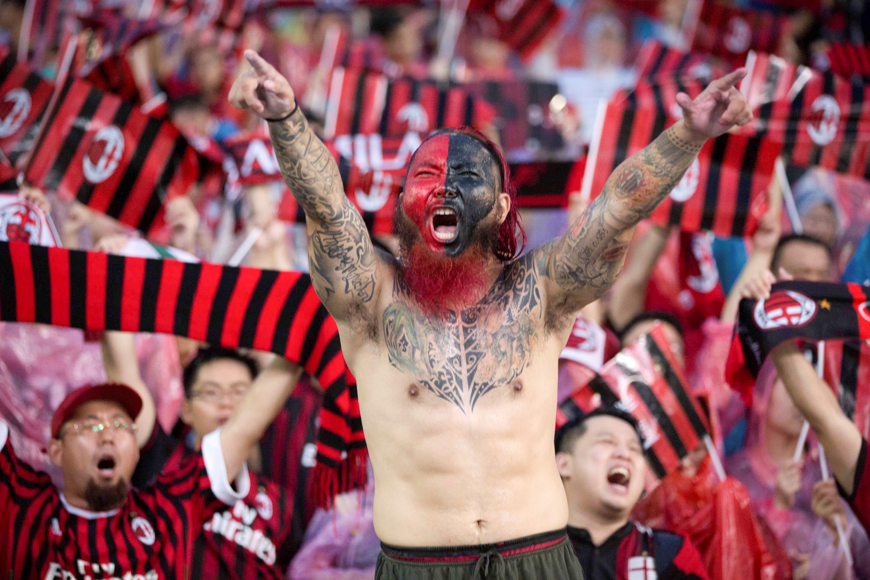 Fans of AC Milan cheer for their team against Borussia Dortmund in Guangzhou. Photo: Reuters