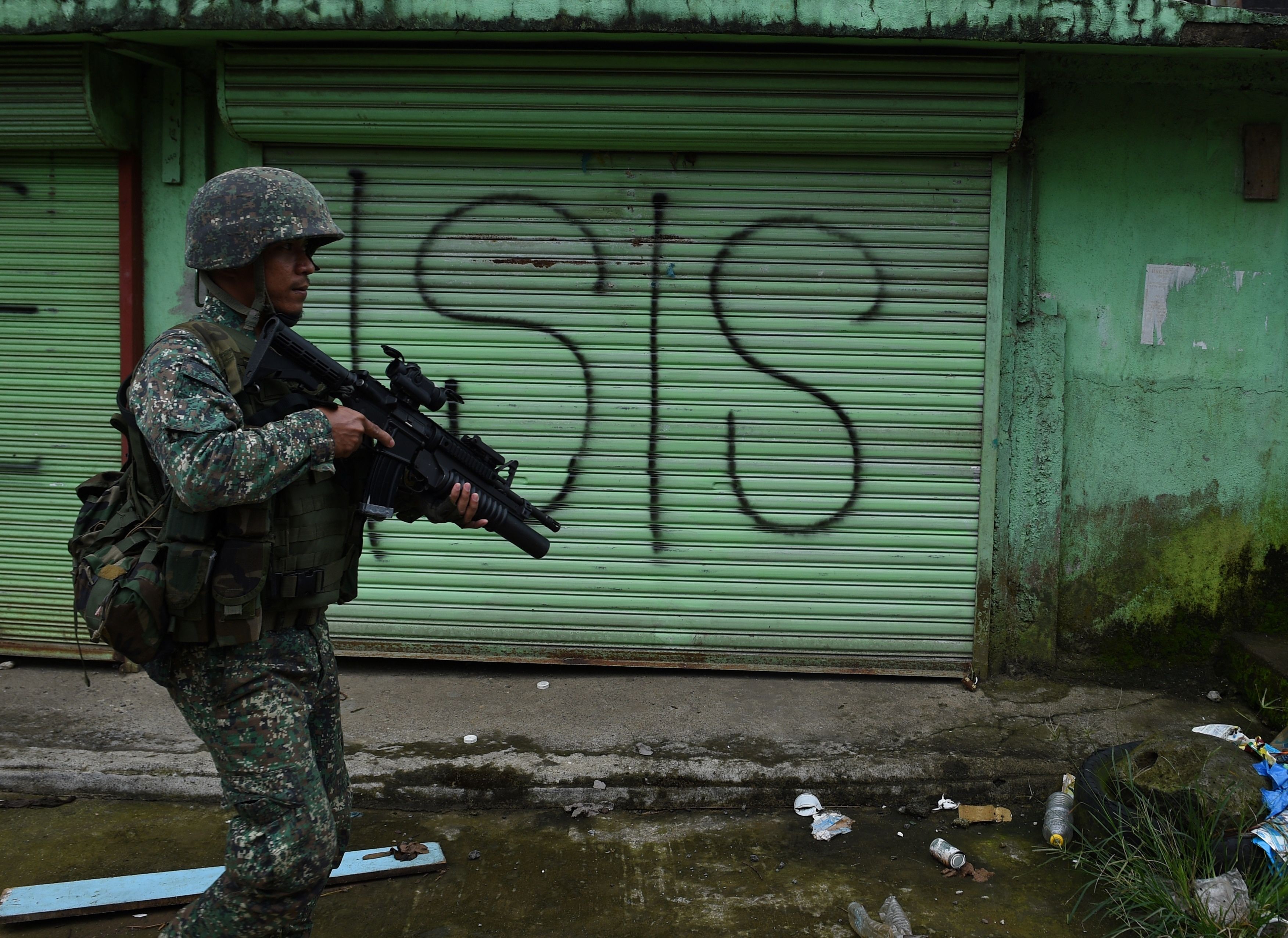 A Philippine marine on patrol along a street in Marawi, Mindanao, where government forces are fighting Islamist militants. Photo: AFP