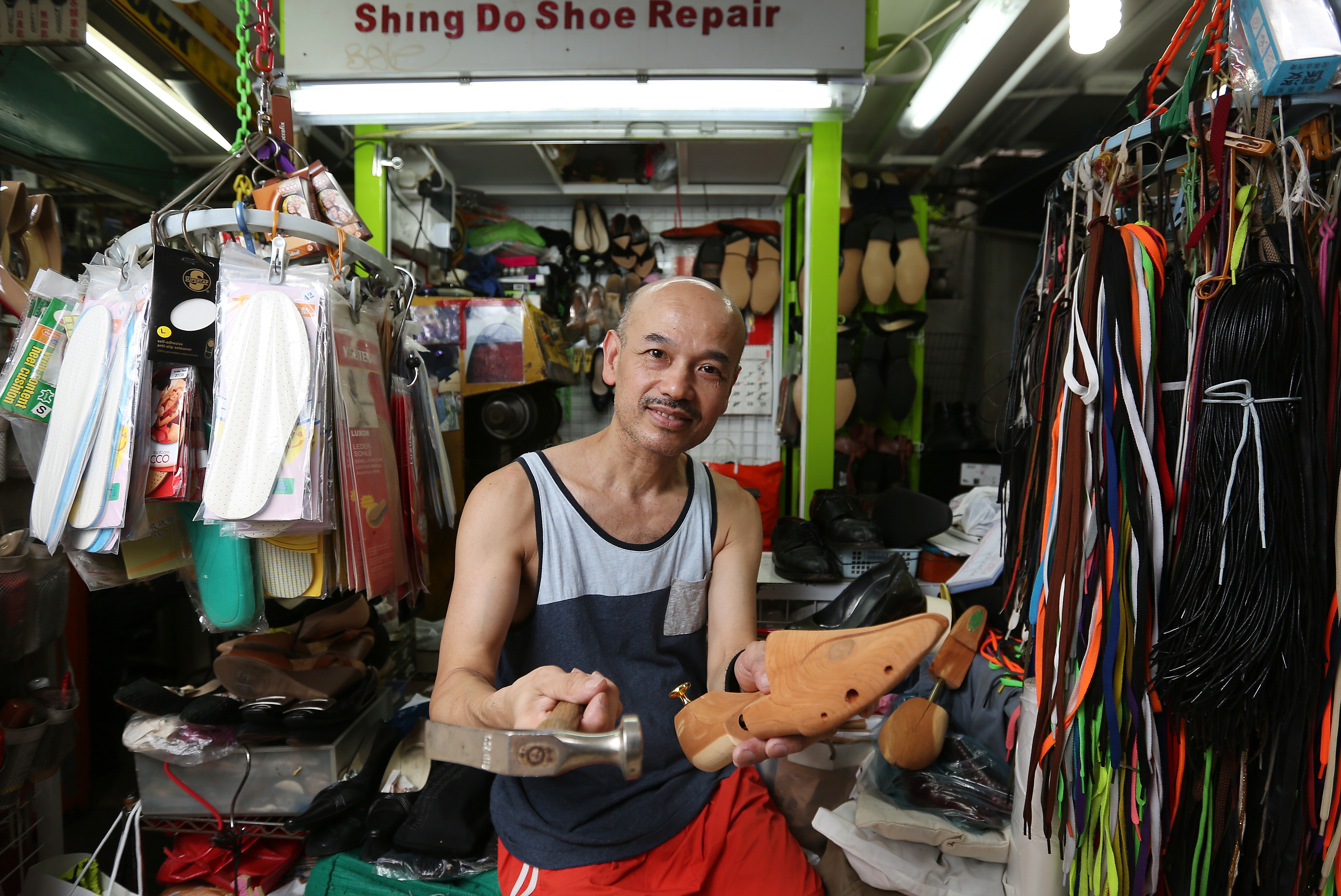 Cobbler Wong Yun-Keung works with his wife in his shop in Central. Photo: Xiaomei Chen