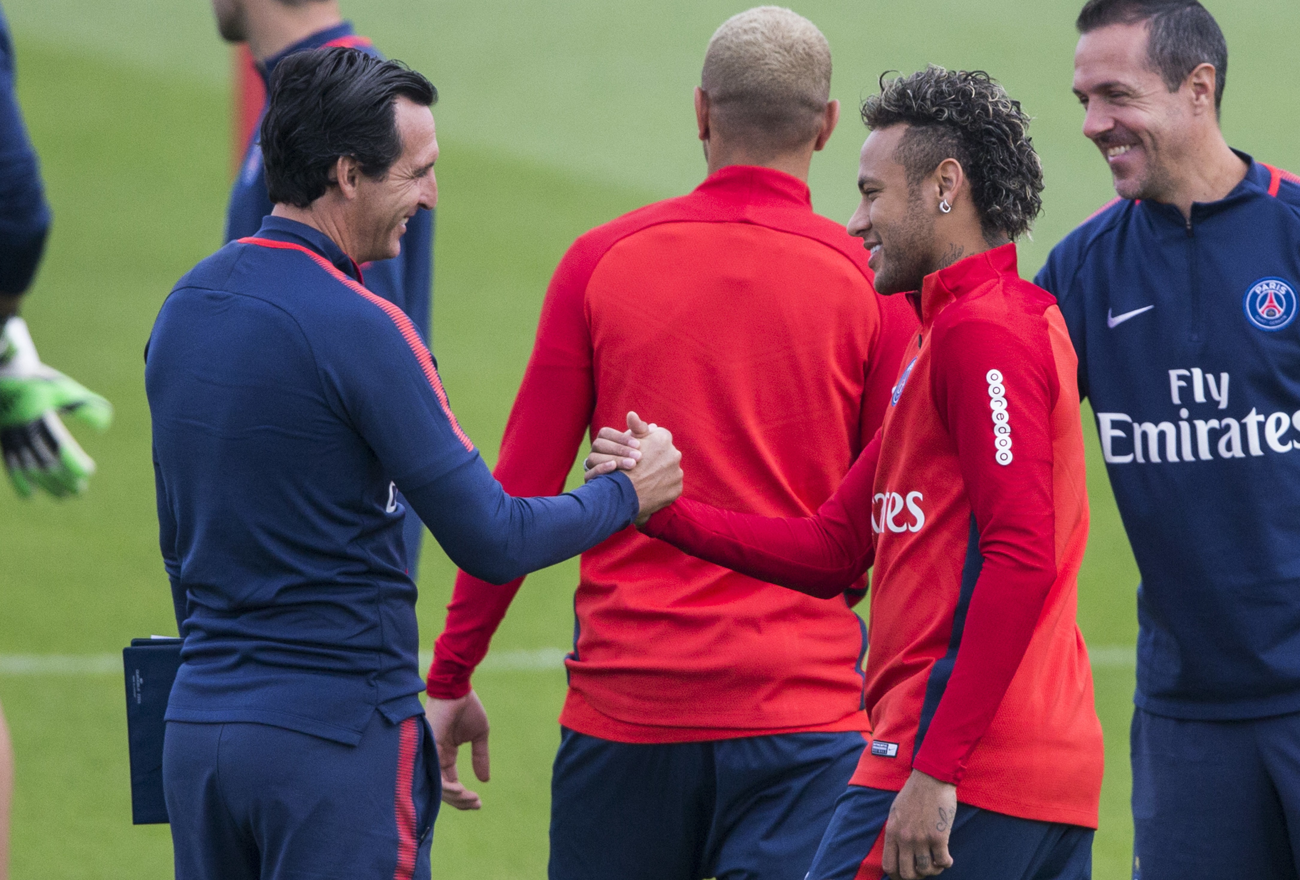 Paris Saint-Germain coach Unai Emery (left) greets Neymar during a training session at the Camp des Loges training centre in Paris. Photo: AP
