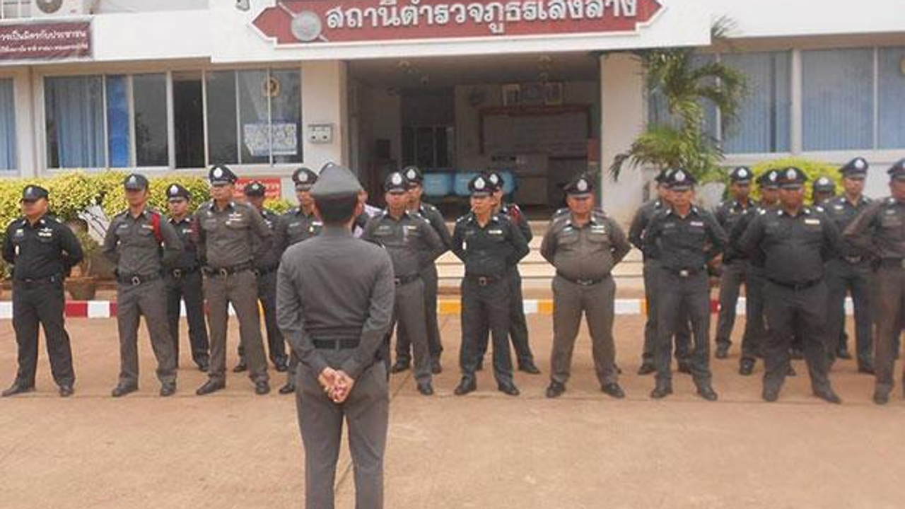 Police at Soeng Sang police station listen to an address by their supervisor after observing the national anthem at 8am. Photo: Prasit Tangprasert/Bangkok Post