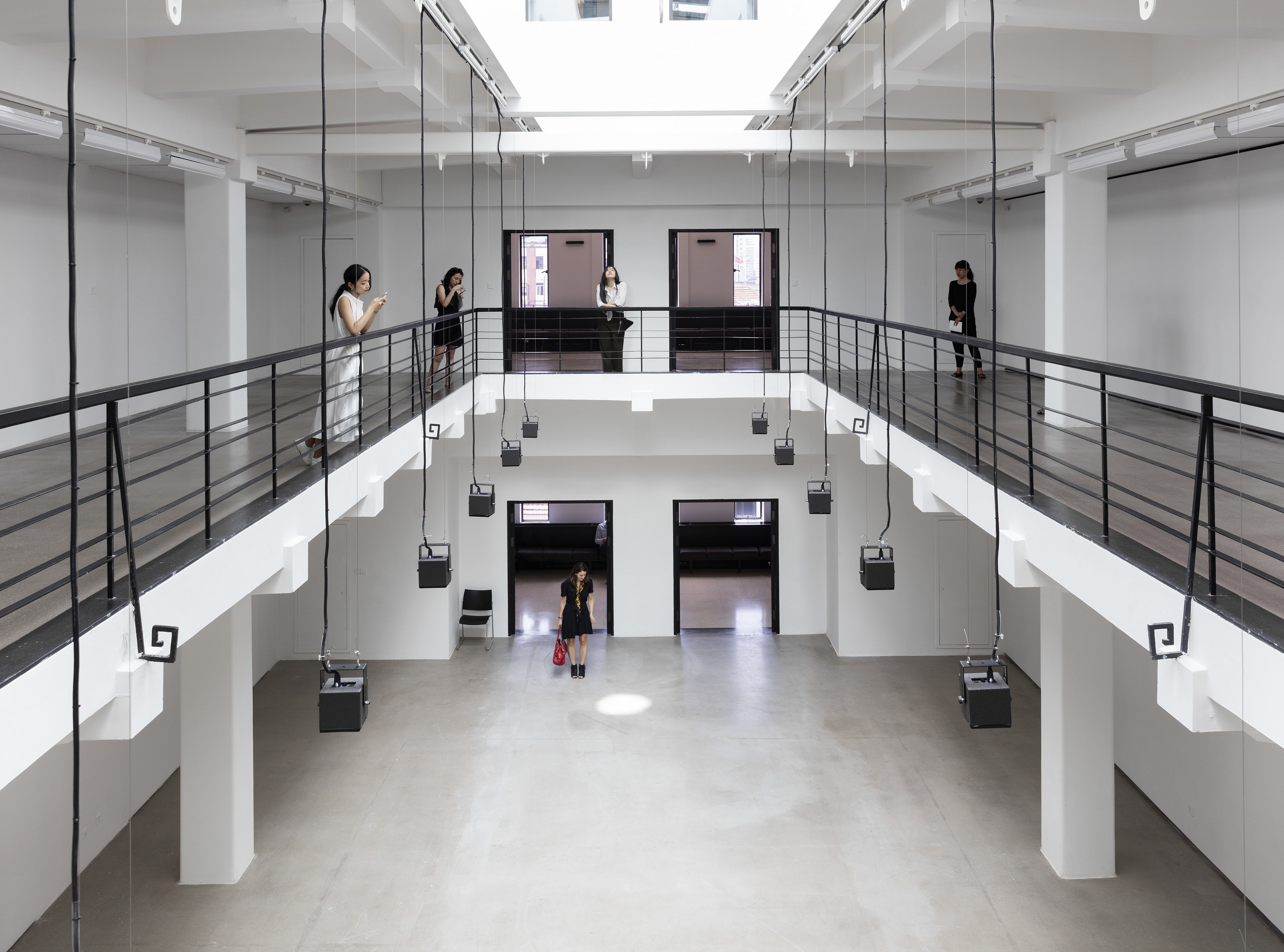 Speakers hanging from the skylight play the music of the natural world – the sound of rainstorms and running water – in Philippe Parreno’s exhibition “Synchronicity”.