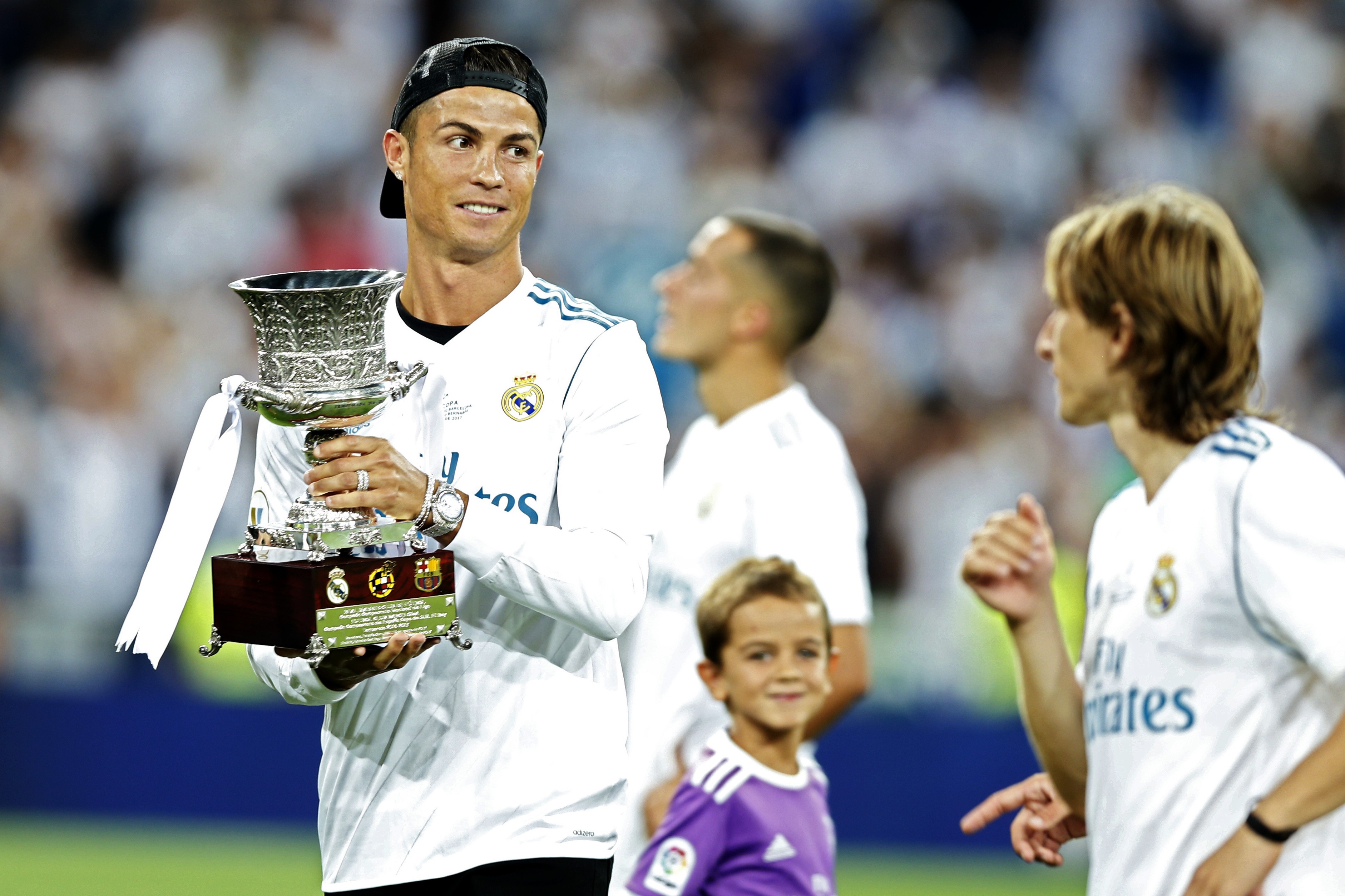 Cristiano Ronaldo holds the trophy while celebrating with teammates after Real Madrid win the Spanish Super Cup. Photo: AP