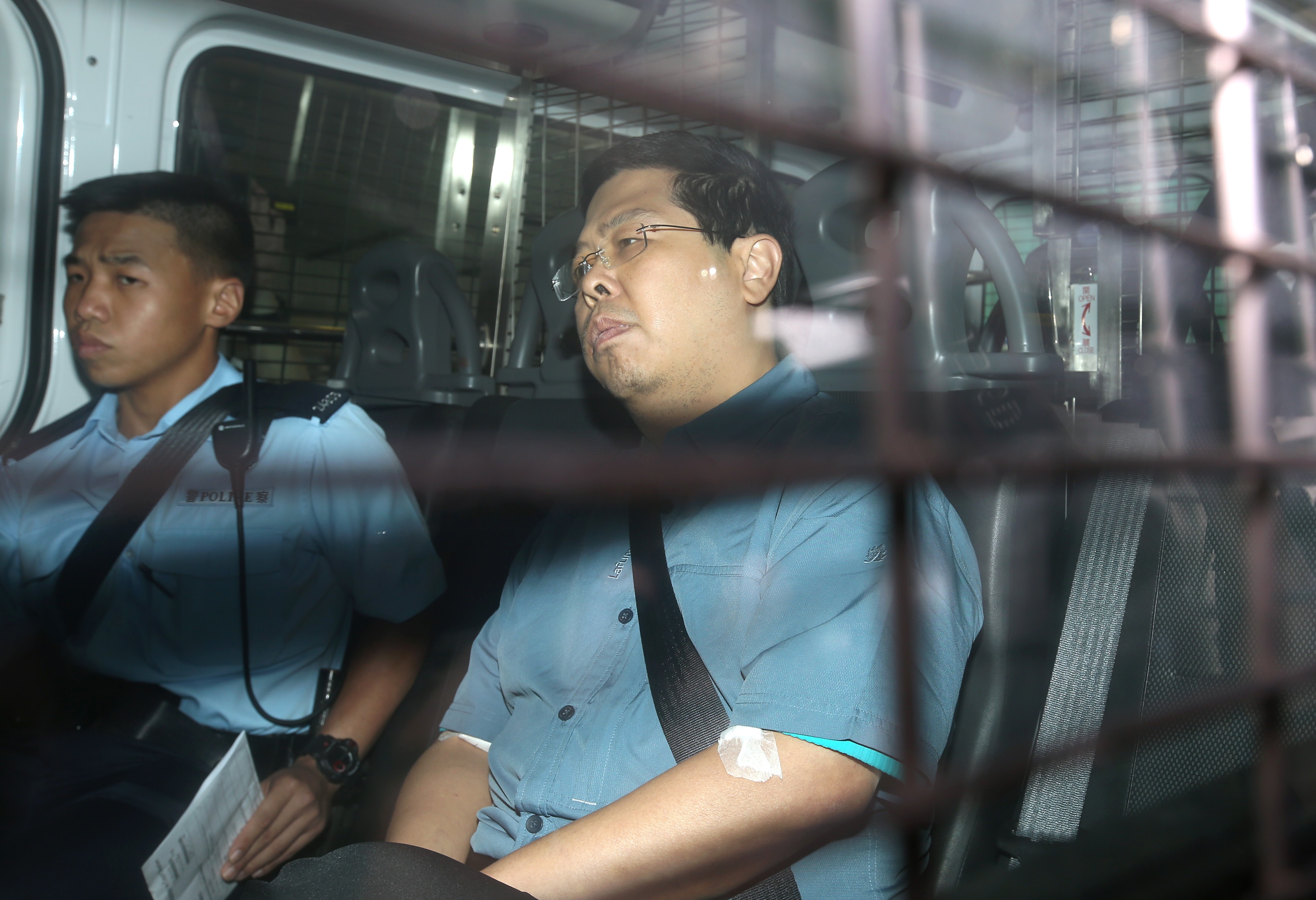 Howard Lam Tsz-kin being escorted to Kowloon City Court by police officers. Photo: K.Y. Cheng