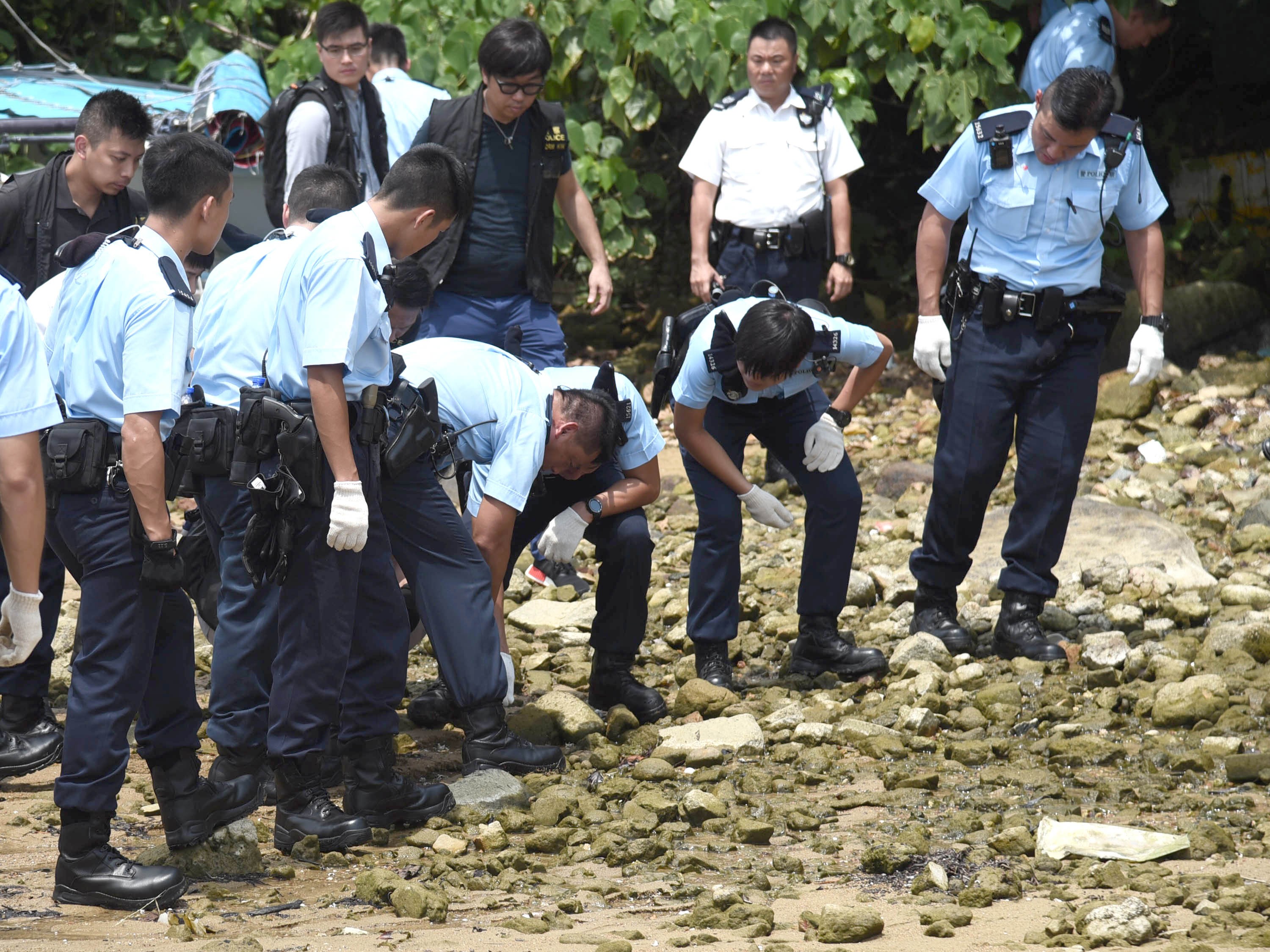 Police officers search for evidence in Tai Mong Tsai in Sai Kung. Photo: Handout